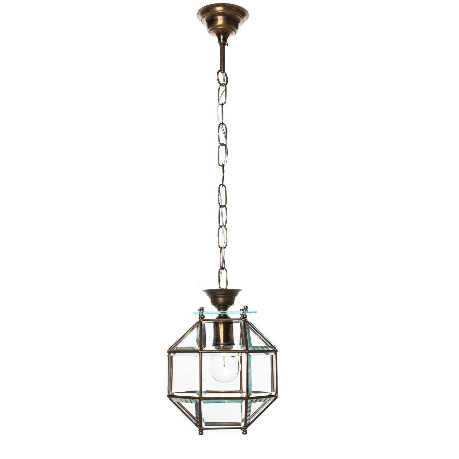 Stylish lantern consist of a brass frame with many fragments made of cut shiny crystal glass, hanging from a thick square glass plate. A wanna have! Manufactured circa 1950s. 
We have a pair and a single piece slightly different (code 143b).
