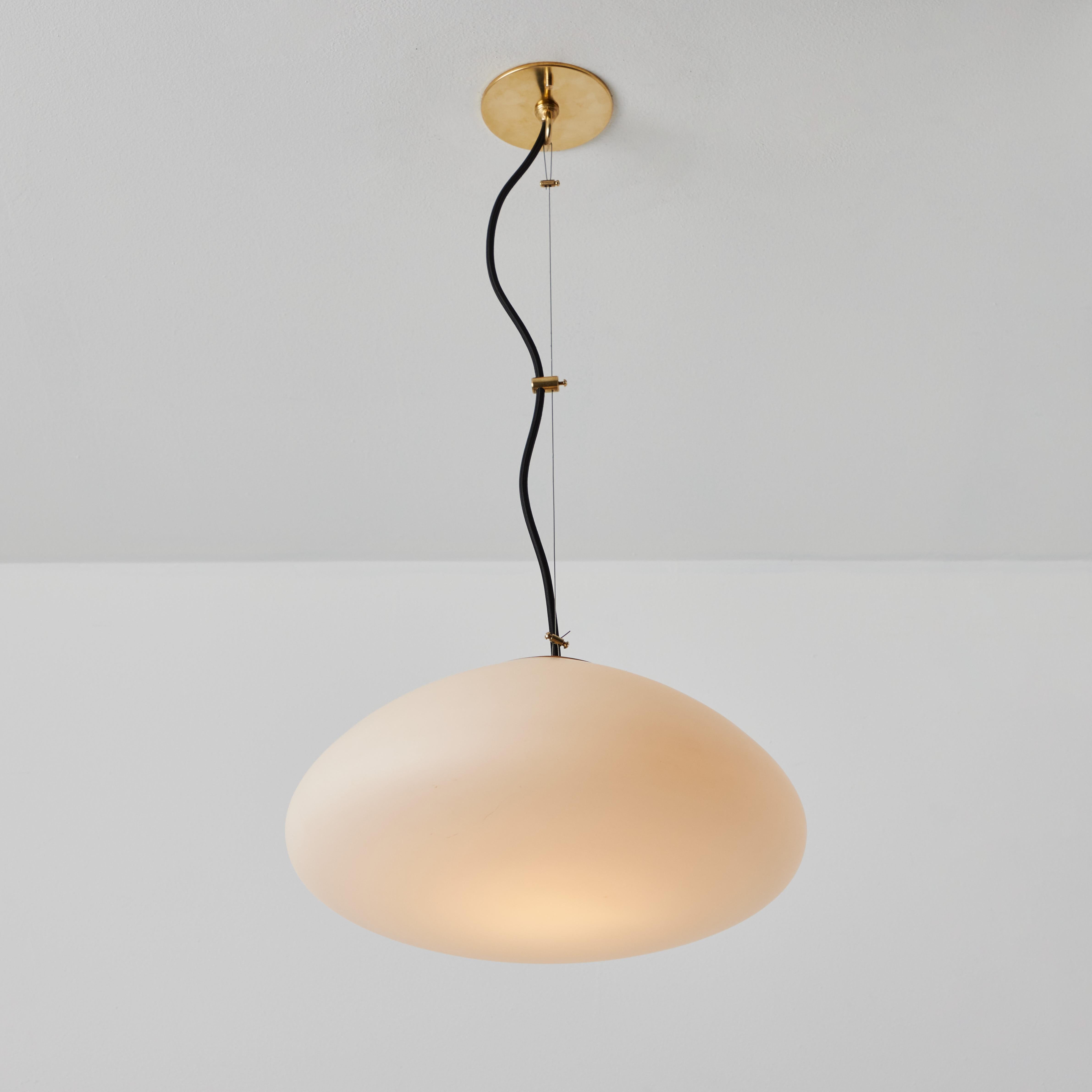 1950s glass & brass suspension lamp Attributed to Stilnovo. A quintessentially 1950s Italian design executed in sculptural opaline glass and brass. A highly functional and refined suspension light of attractive scale and incomparable refinement.