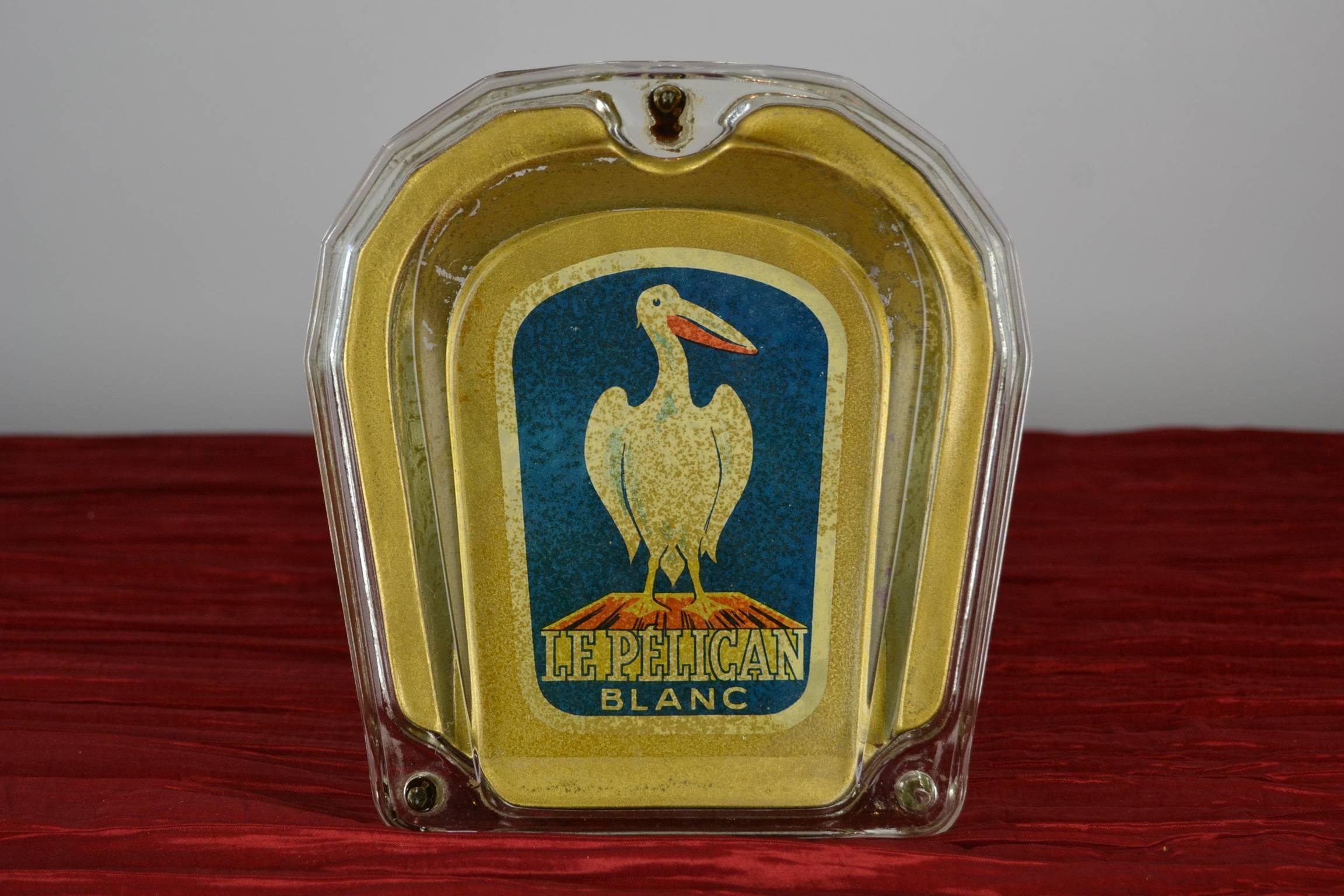 Vintage Money Valve  - Ramasse-Monnaie for The White Pelican. 
Vintage Counter Display - Advertising Display. 
The White Pelican is known for the high quality of Fountain Pens , Ballpoints and Ink. 
This heavy and stabile glass Money Valve was used