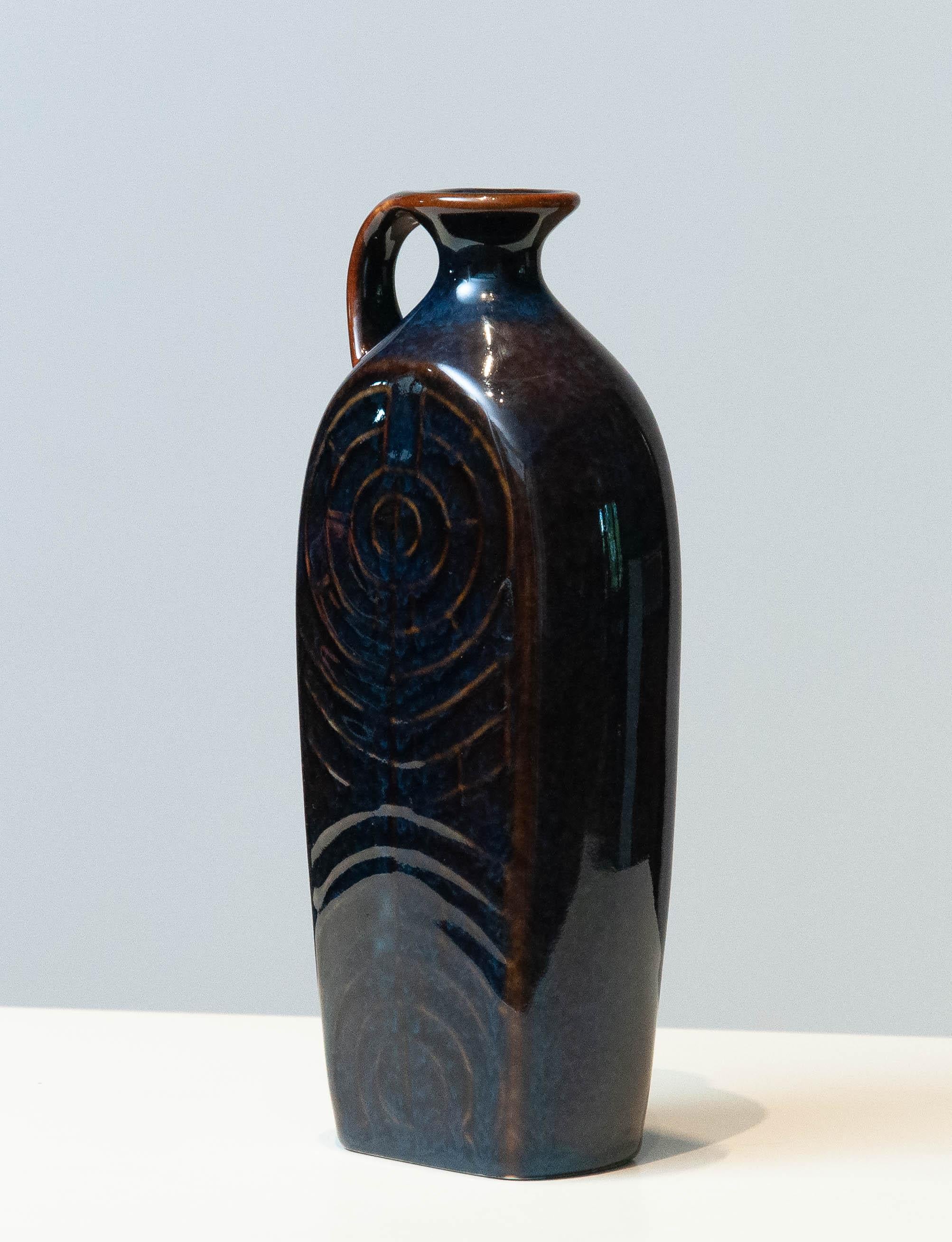 Fantastic glazed pitcher / vase made by Carl-Harry Stålhane for Rörstrand Sweden in the 1950's. The extremely beautiful combination of blue and brown colors mixed glazed and the slim design makes this pitcher iconic and examples for the best design