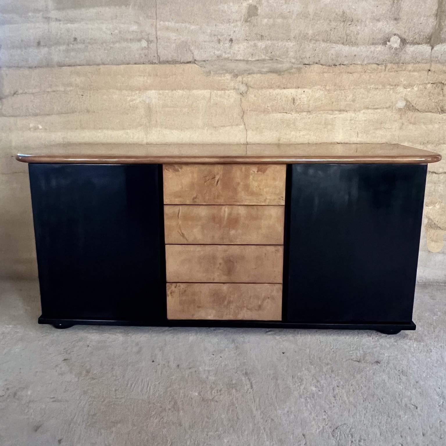 1950s Luscious Goatskin Credenza-Sideboard-Cabinet. 
68 w x 31 h x 21.25
Open storage left and right sides with glass shelves. 
High quality brass pins hold glass in place. 
Sideboard Cabinet has original black gloss finish. 
Tabletop and 4 drawers