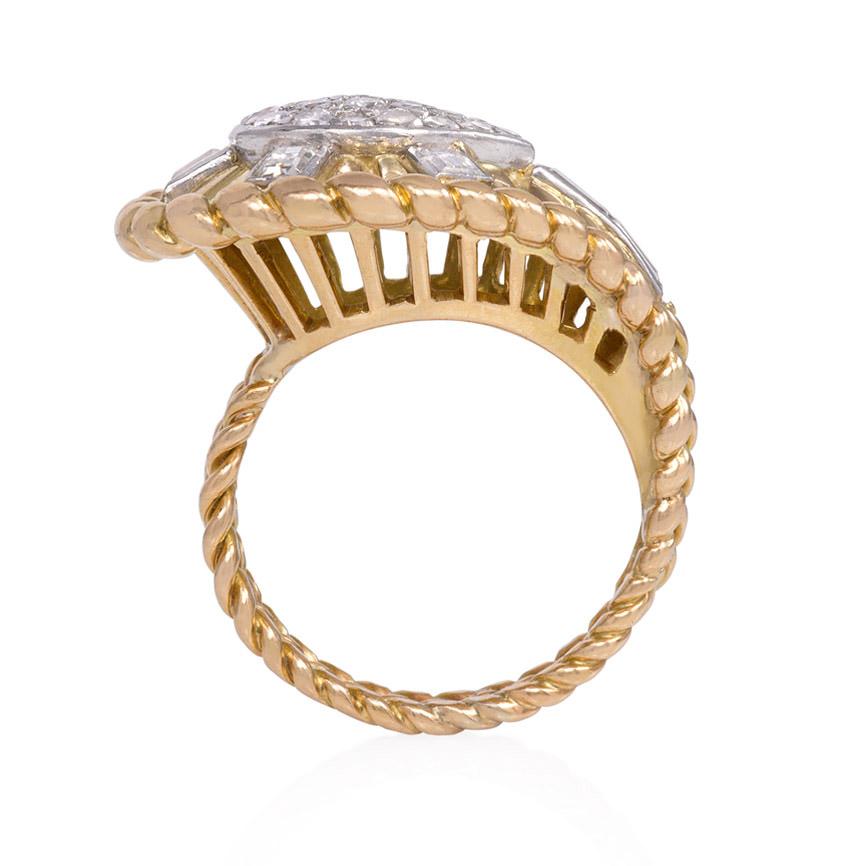 A mid-century gold and diamond cocktail ring of tapering and radiating teardrop design with a rope twist border and raised openwork gallery, in 18k and platinum.  French import marks.  Atw single, full cut, and baguette diamonds 1.12 cts.

Top