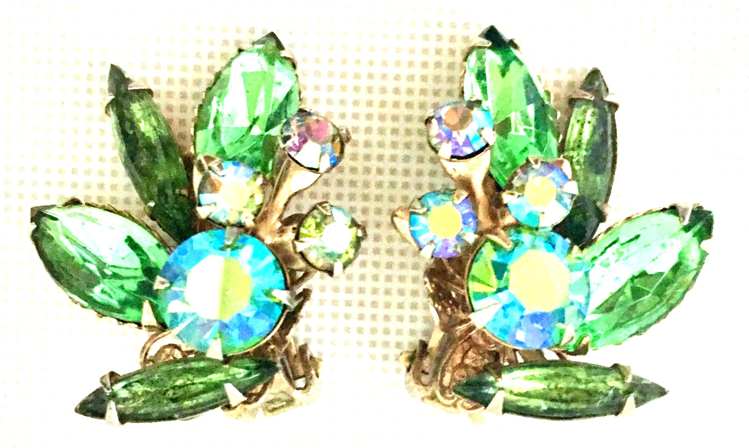 1950'S Gold & Austrian Crystal Abstract Floral Earrings. Features gold plate metal. dog tooth prong set brilliant marquis shaped green stones and round aurora borealis stone detail. These clip style earrings are most likely made by Regency and are