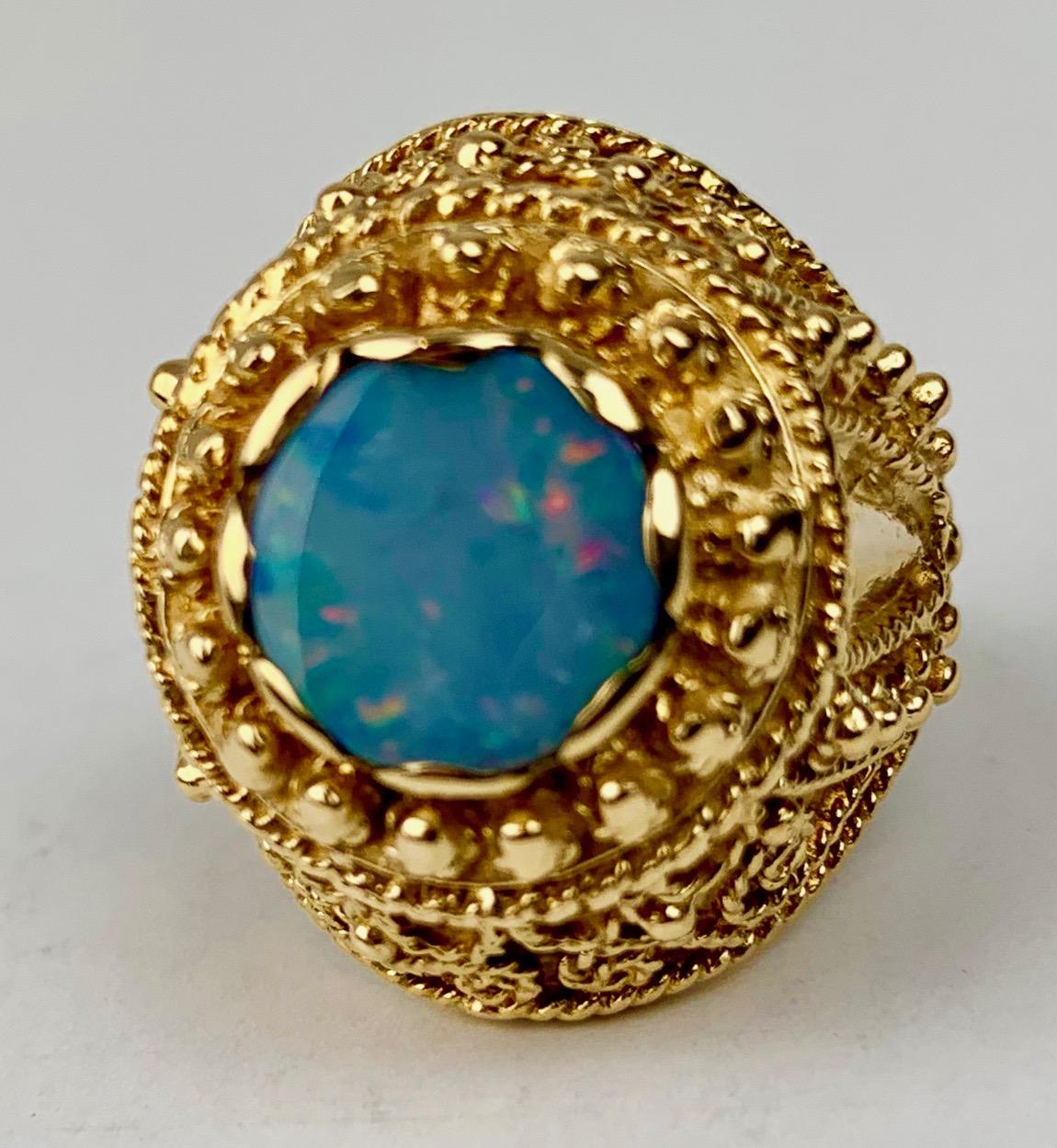 Custom 1950's 14 karat yellow gold domed ring set with a doublet opal.  There are applied scrolls, rope work and beads.  Custom made for my client.
Professionally cleaned and polished.
11.2 grams
size 6.75 (can be sized)