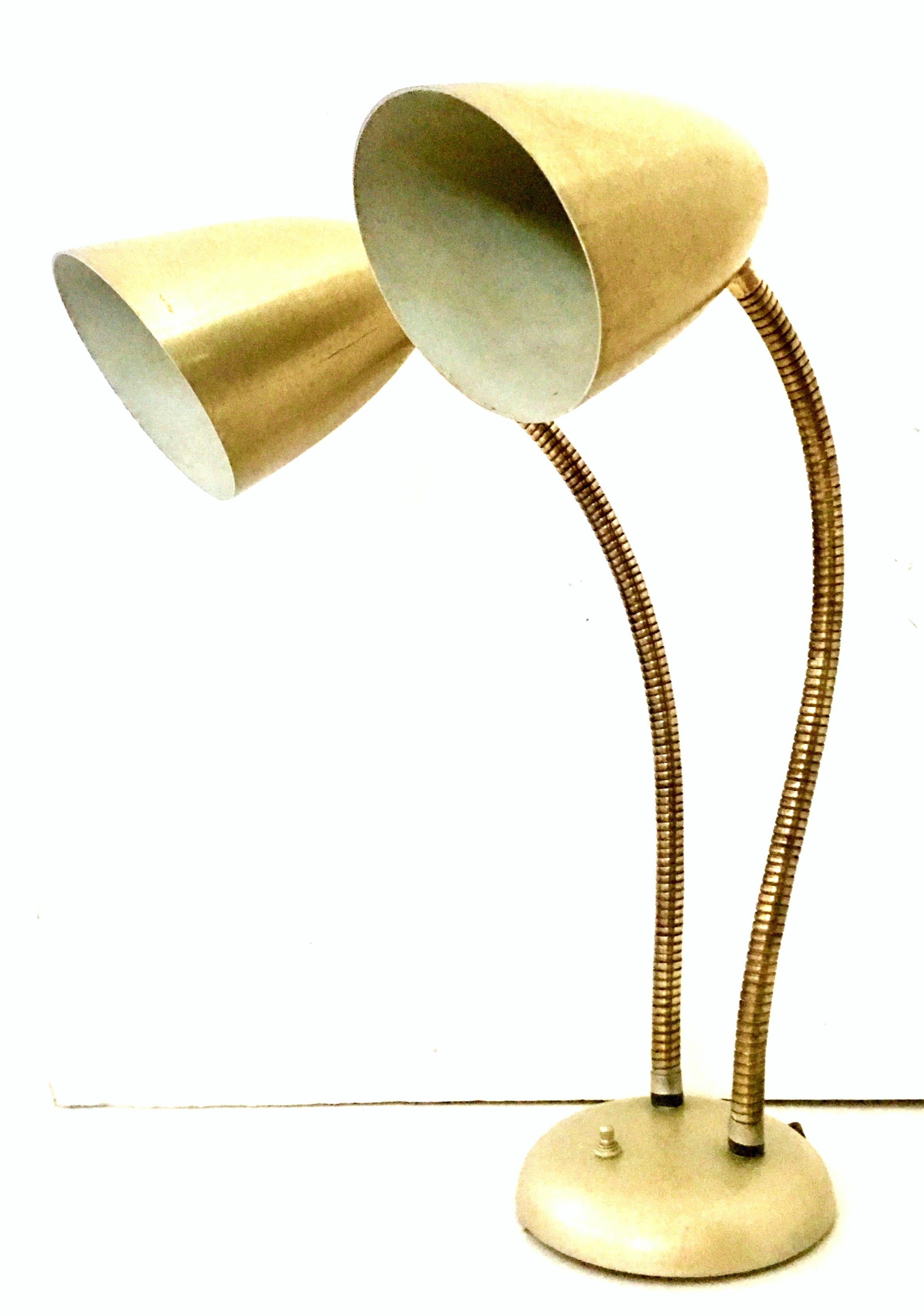 1950'S Gold metal enamel double cone shade goose neck lamp by Prescolite-USA. This double cone shade metal and brass gold goose neck lamp features 360 degree pivoting brass coil arms, a three way switch at the base and accommodates standard three
