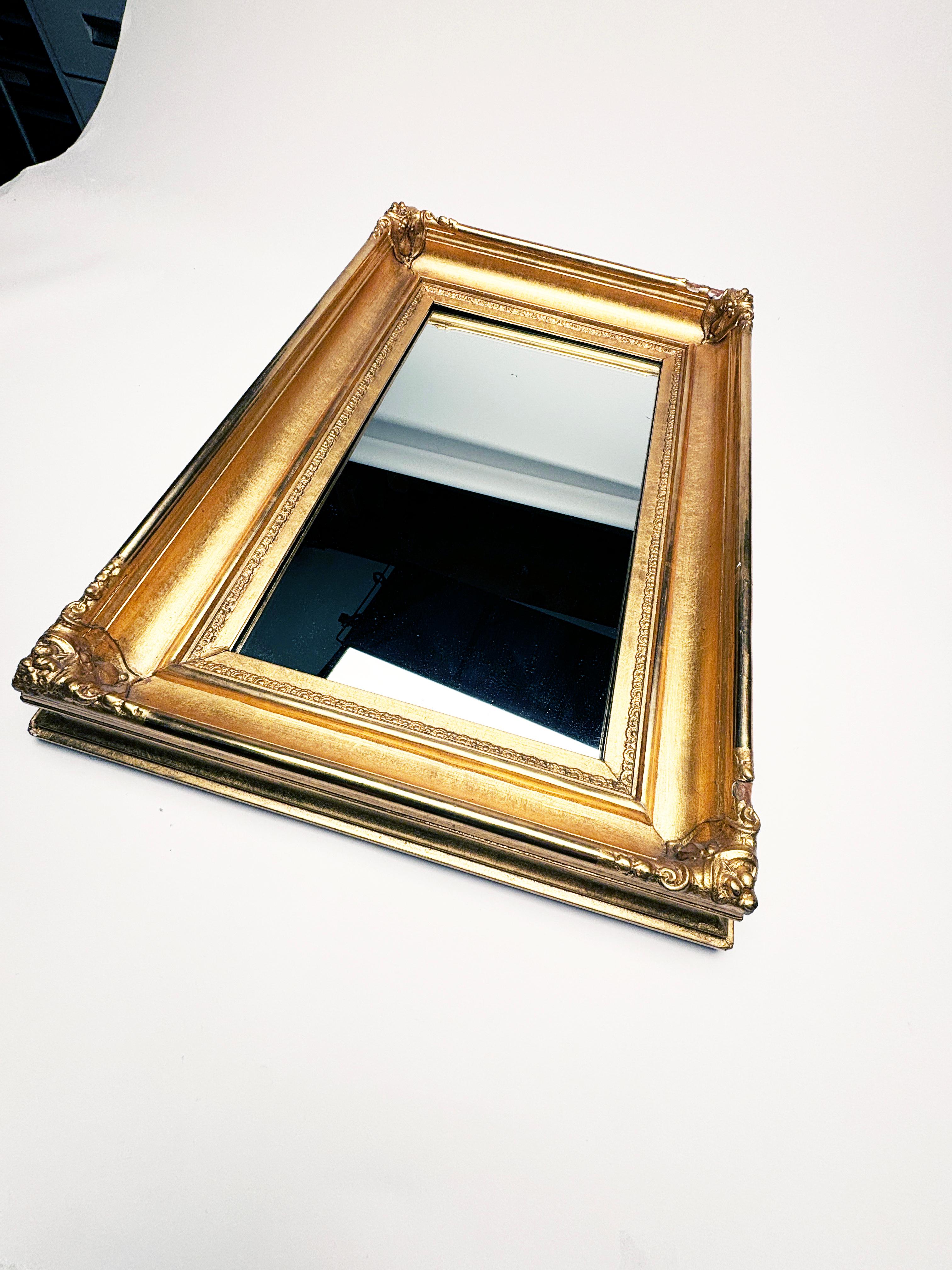 This gorgeous gilt-wood mirror originated in the 1950's and has been holding its own ever since. As classic and simplistic design along with its thick framing makes this mirror a must have for a wall arrangement or as a stand alone in a bath.