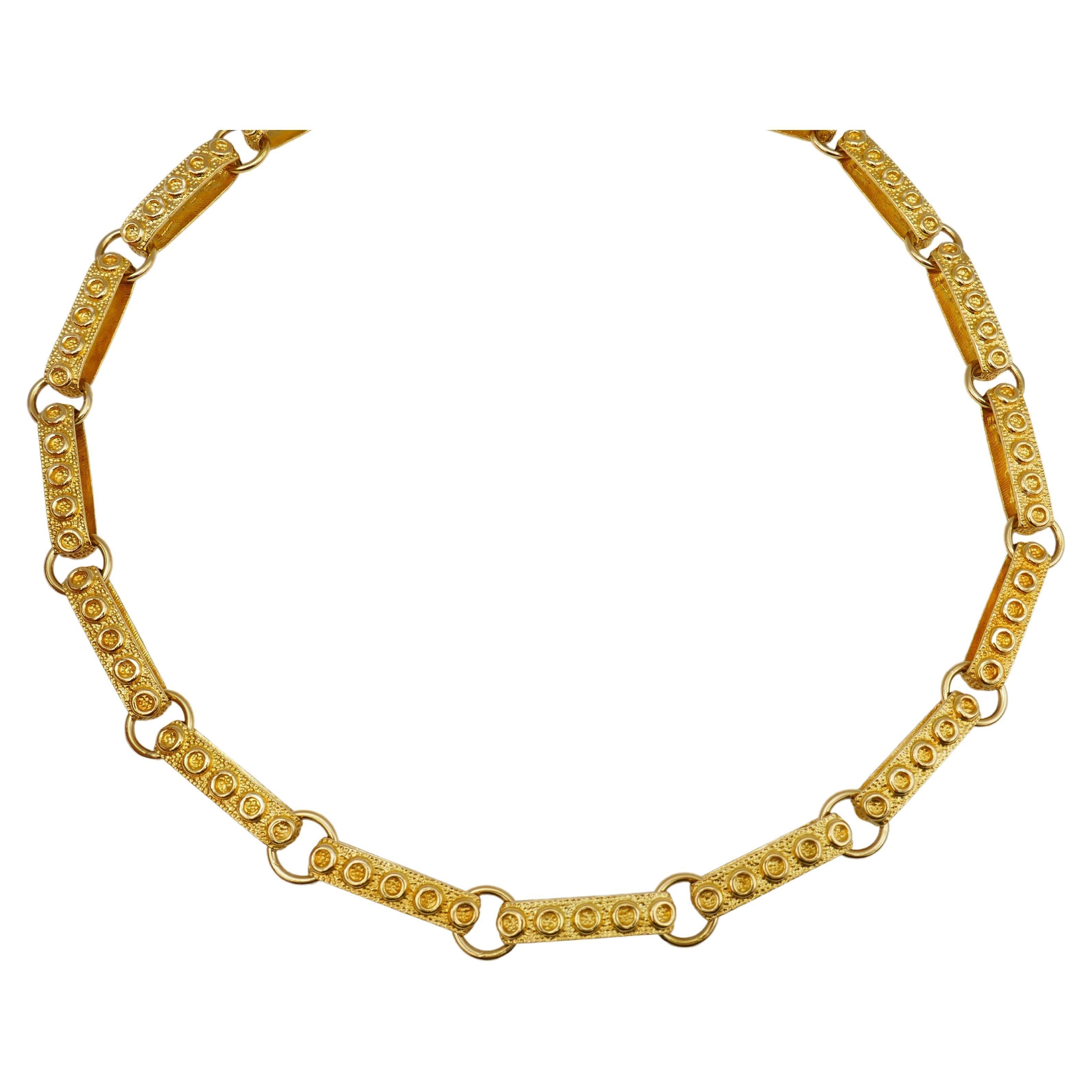 A great example of 1950s jewelry, this 14k gold necklace has all the attributes of the post-war era. It's a bold, cheerful and head-turning piece. The links comprise of long hammered gold loops. The length allows to wear this necklace doubled around