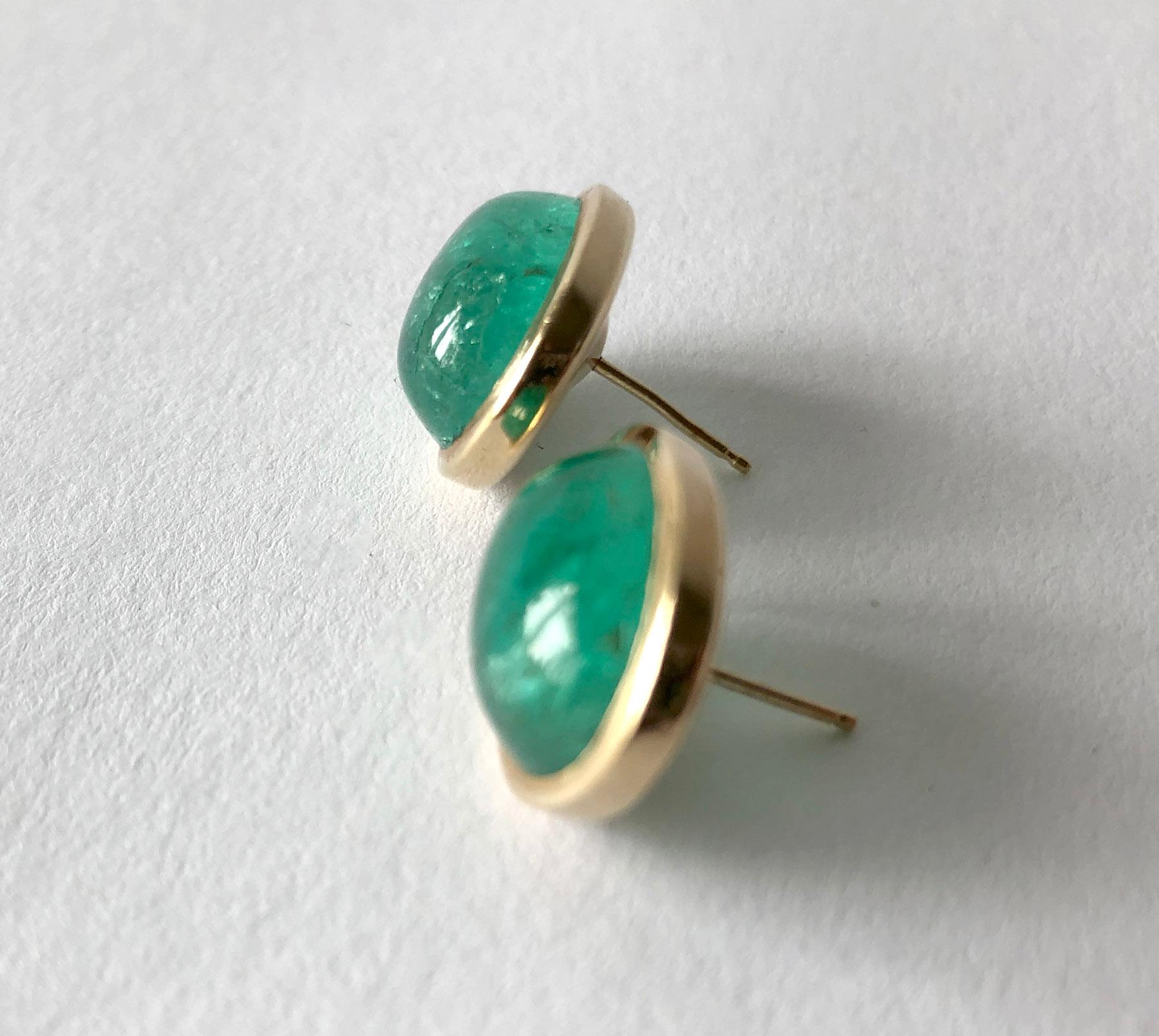 Pair of oval emerald earrings set in gold, circa 1950's.  Earrings are rich in color with natural inclusions. The emeralds are approximately 9 ct each.  The overall measurement of the earrings are 3/4