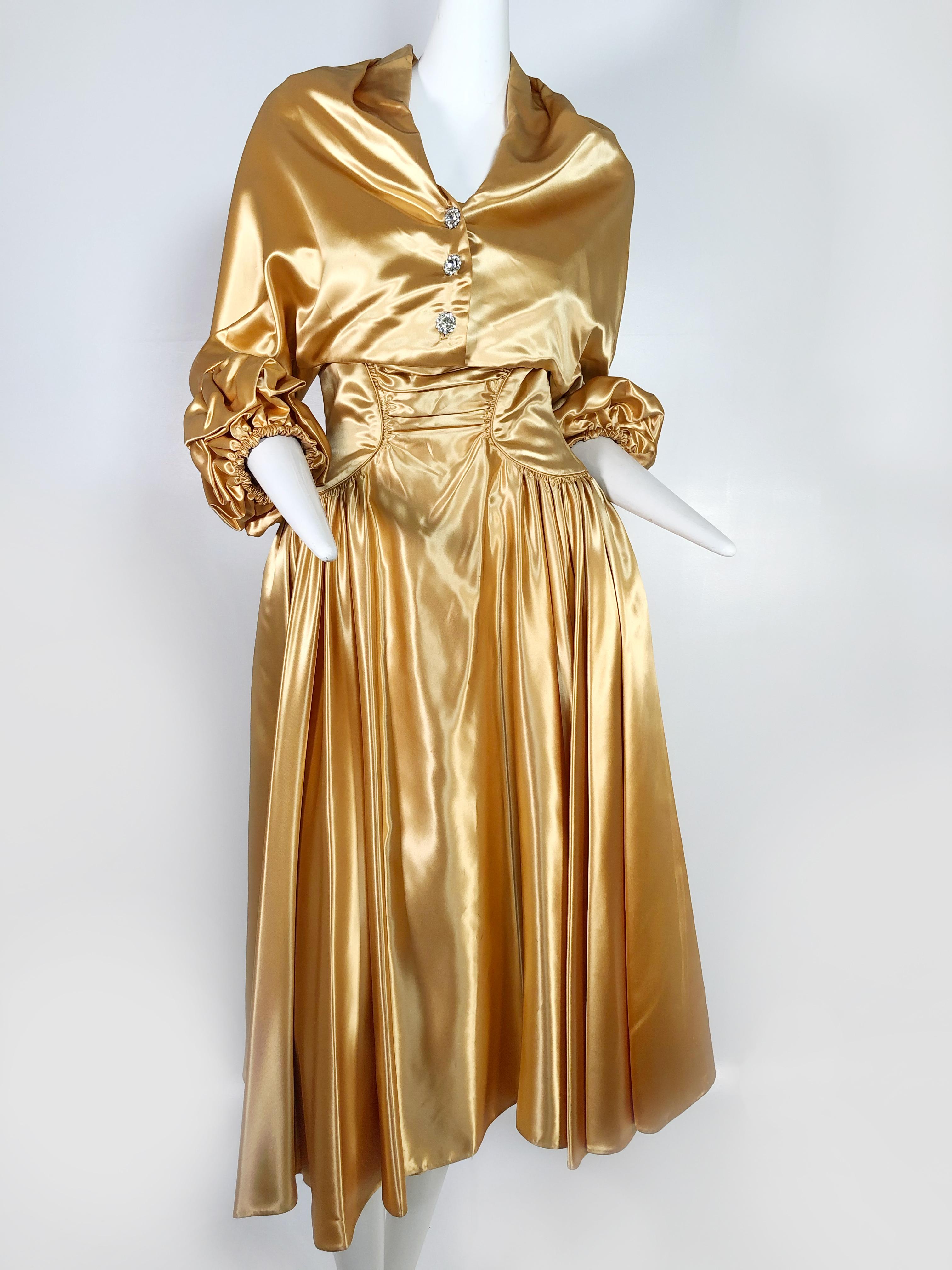 A gorgeous, unmarked as to maker, 1950s gold silk satin strapless dress and jacket ensemble:  dress features a full skirt and constructed zipper back bodice with unusual 