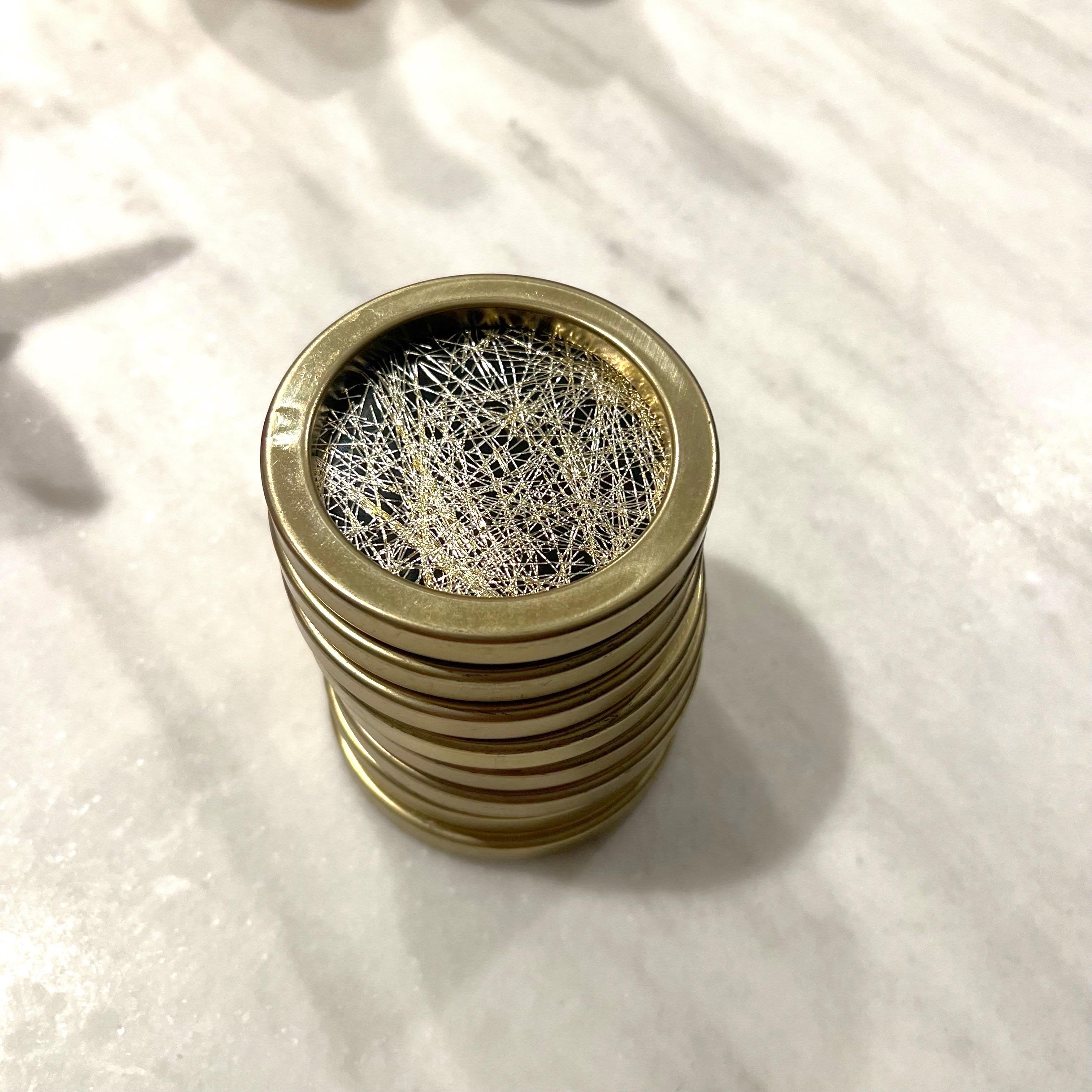 8 Confetti Lucite Drink Coasters Gold Glitter Set Party Barware Metal Plastic.

These coasters have a brass colored metal rim and black metal bases. The center is confetti lucite ranging from gold to a copper color.  These are great addition to your