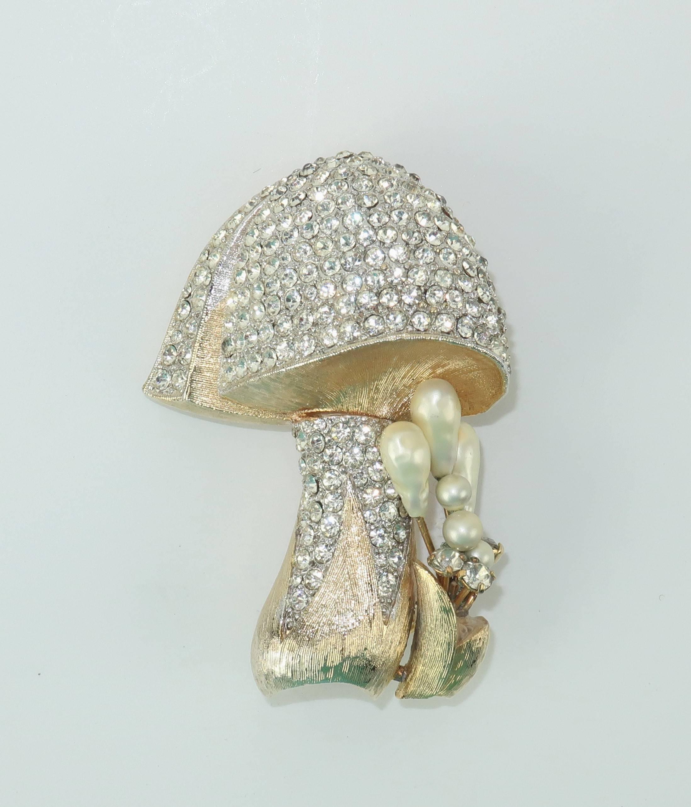 Add a whimsical piece of flora to your lapel with this gold tone mushroom brooch accented with crystal rhinestones and faux pearls.  The adorable 1950's accessory measures 2