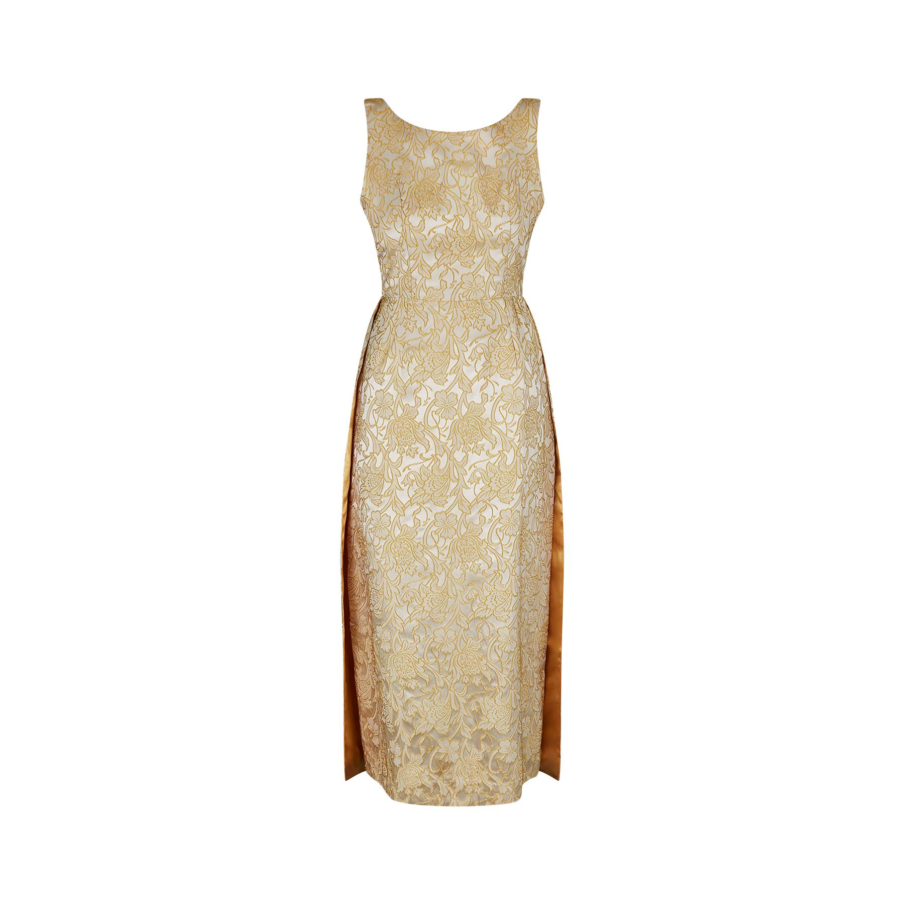 Original 1950s floral jacquard column dress with double train. The fabric of this dress is sensational and it catches the light beautifully; it is almost silver looking against a raised floral element outlined in deep golden yellow.  This dress is