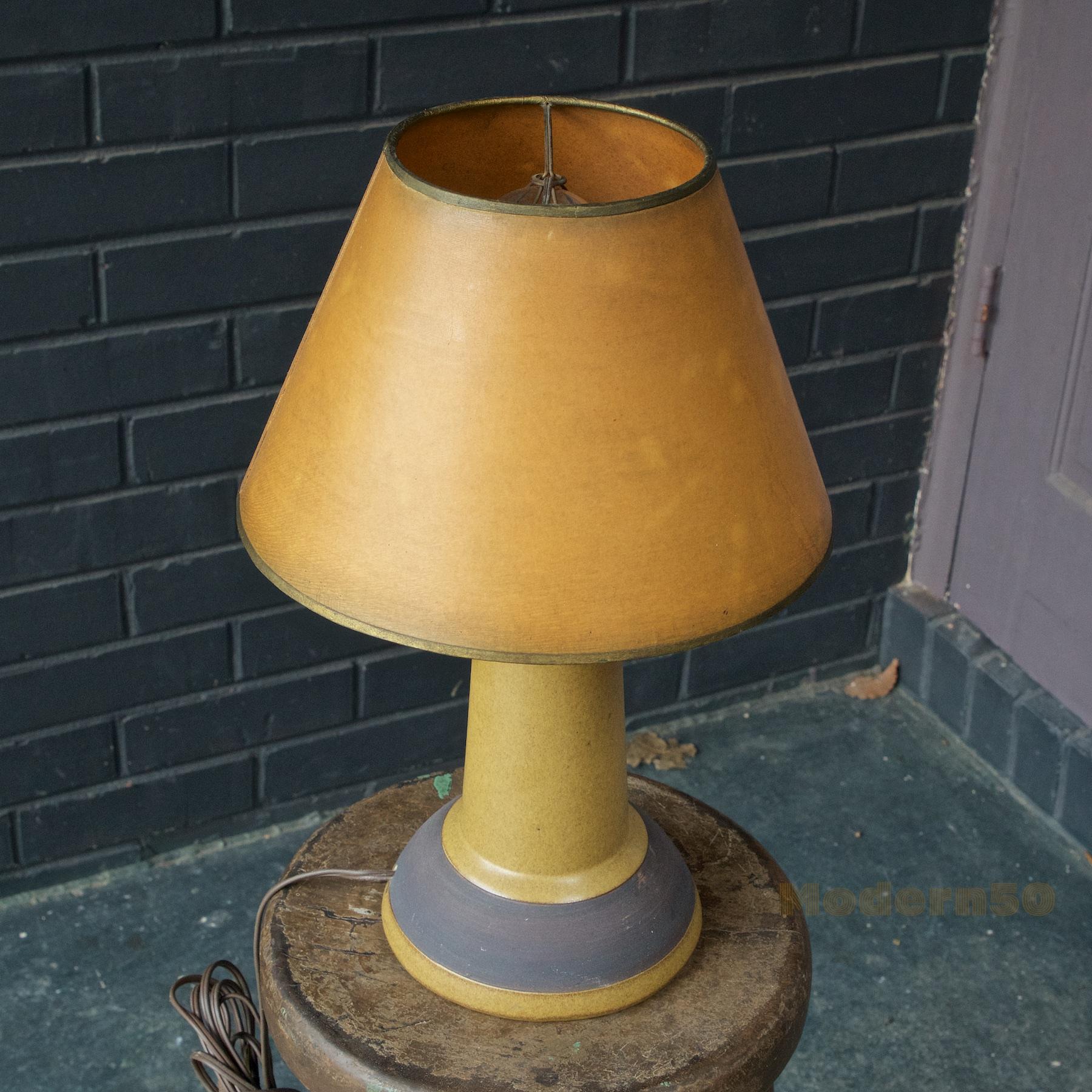 Nice 1950s Martz table lamp with a more Usonian and Art & Crafts influence, matched to an older Marshall Studios made harpless shade. Lamp ceramic body is a diameter of 6 by a height of 9 inches.
      
