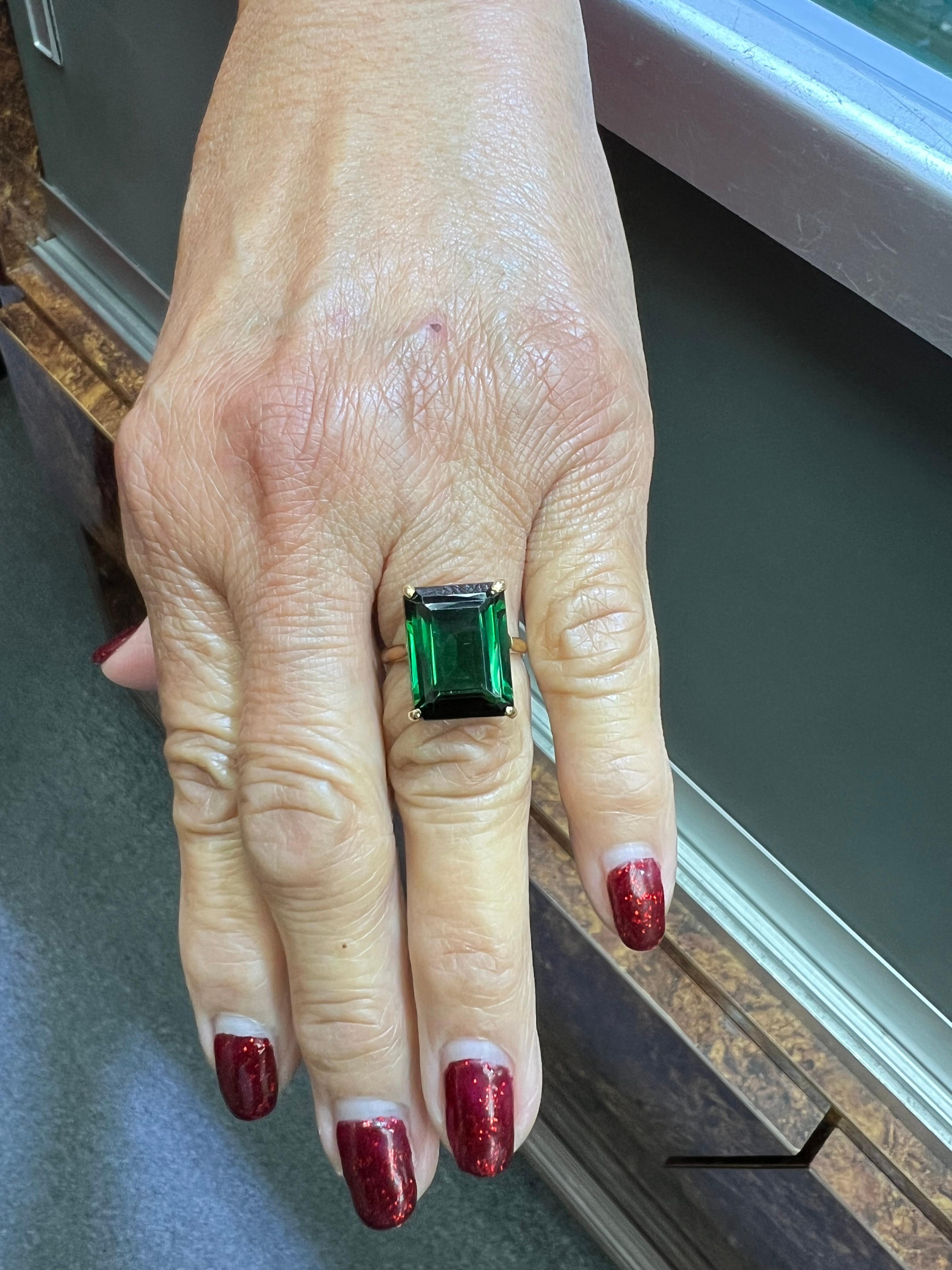1950s Green Tourmaline Yellow Gold Solitaire Ring.

 The Emerald Cut Green Tourmaline is mounted in this hand-made 14k ring mounting from the 1950s.  It's very simple and elegant with just a few simple touches.

SPECIFICATIONS:  

 TOURMALINE:  One