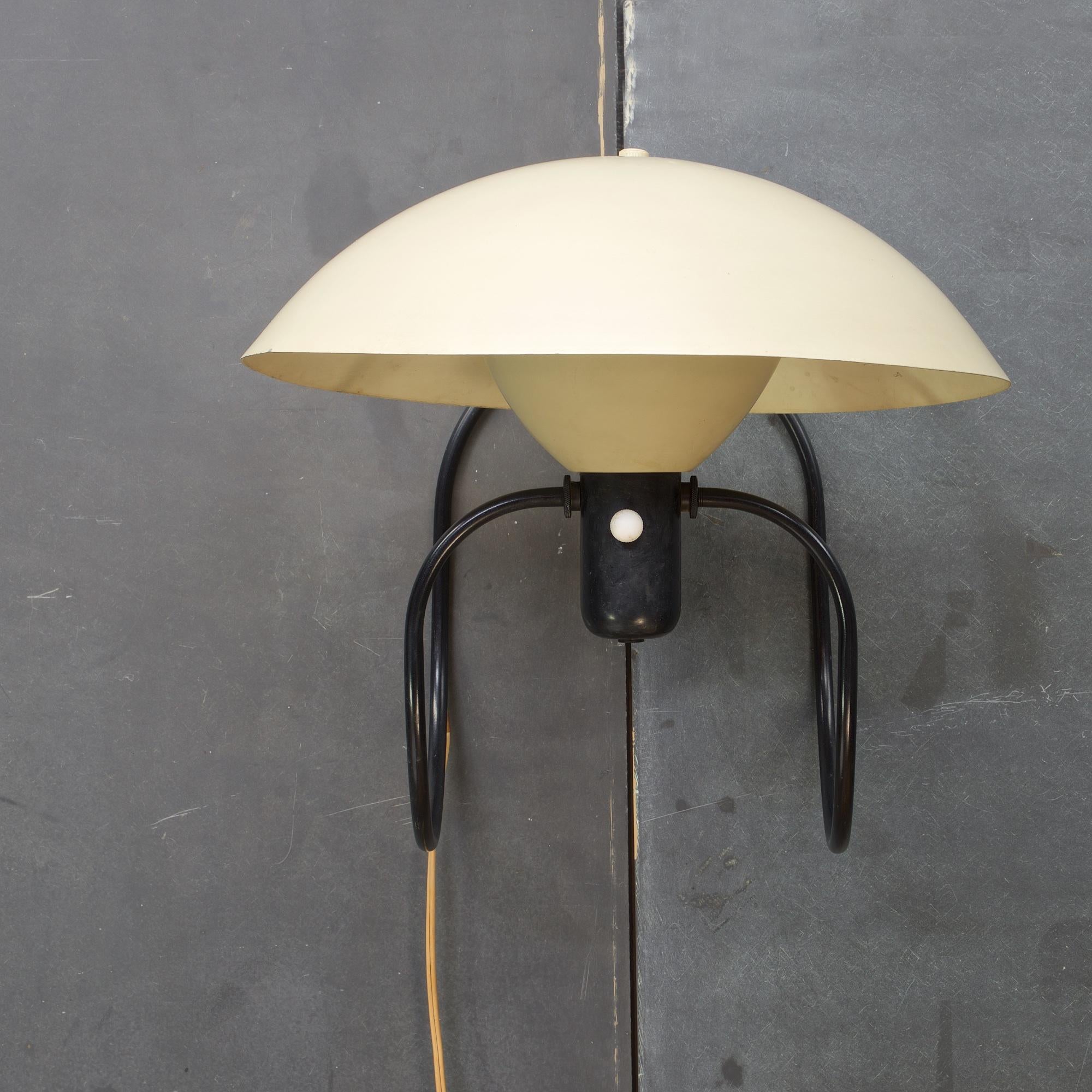 A wonderful and rare piece of postwar modernism, and the most famous design by Greta Von Nessen (1898-1975). The aluminum and enameled steel Anywhere Lamp, 1951. Though, 