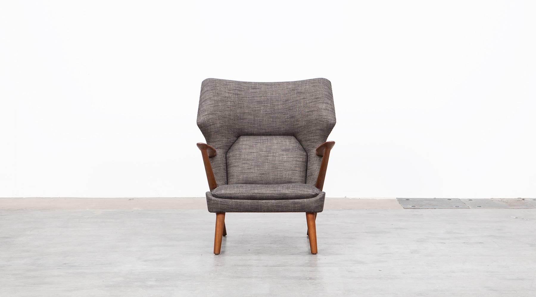 Lounge chair with matching ottoman designed by Danish designer Kurt Olsen. Specially worked cushions in seat and back area. The wooden frame is reworked as well as newly upholstered with high-quality fabric. This chair is a cheaper alternative to a