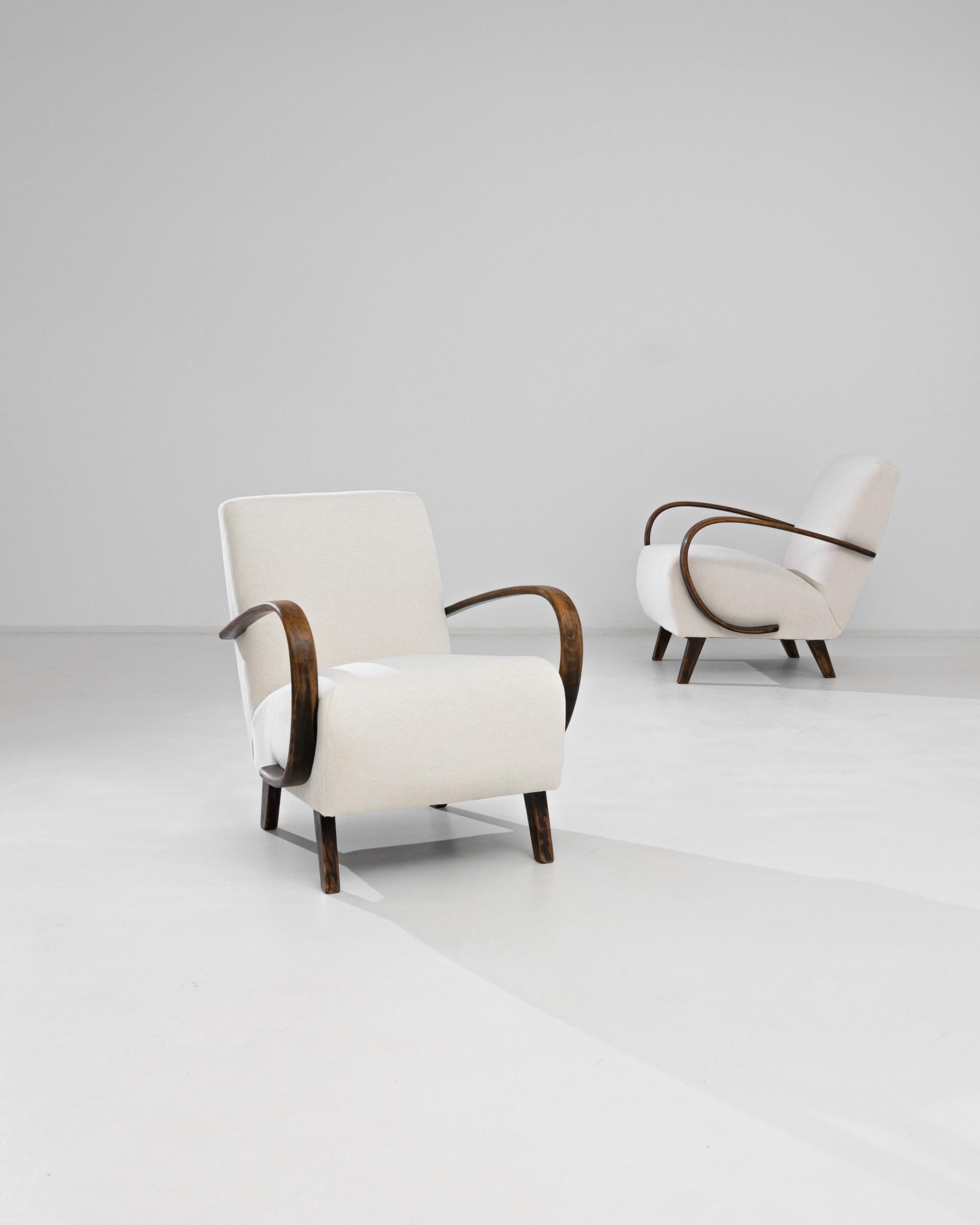 A pair of armchairs by Czech furniture designer J. Halabala. Made in the 1950s, variations on bentwood furniture were produced in Central European furniture factories throughout the 20th Century. The eye-catching silhouette and comfortable shape has