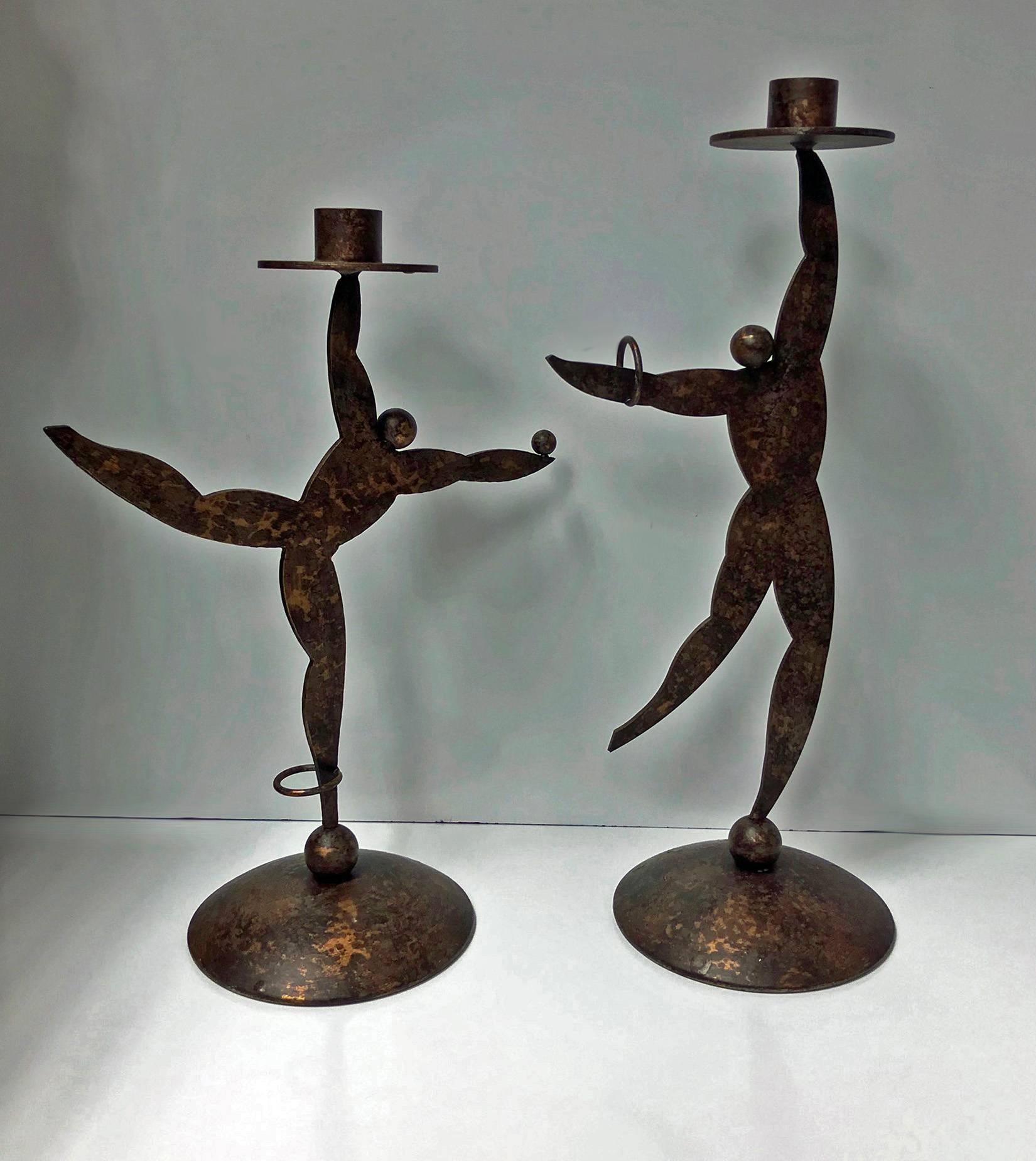 1950s Hagenauer style candleholders in the form of dancers. Each of patinated cut sheet brass, probably Austrian. Heights: 15.25 and 13.25 inches respectively. Breadths: 6.50 and 9.75 inches respectively.