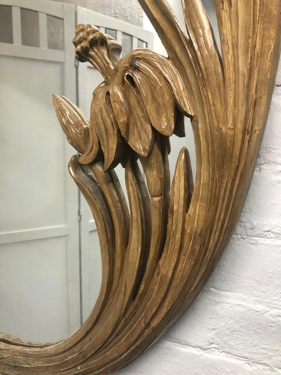 1950s hand carved, oval shaped, floral mirror.