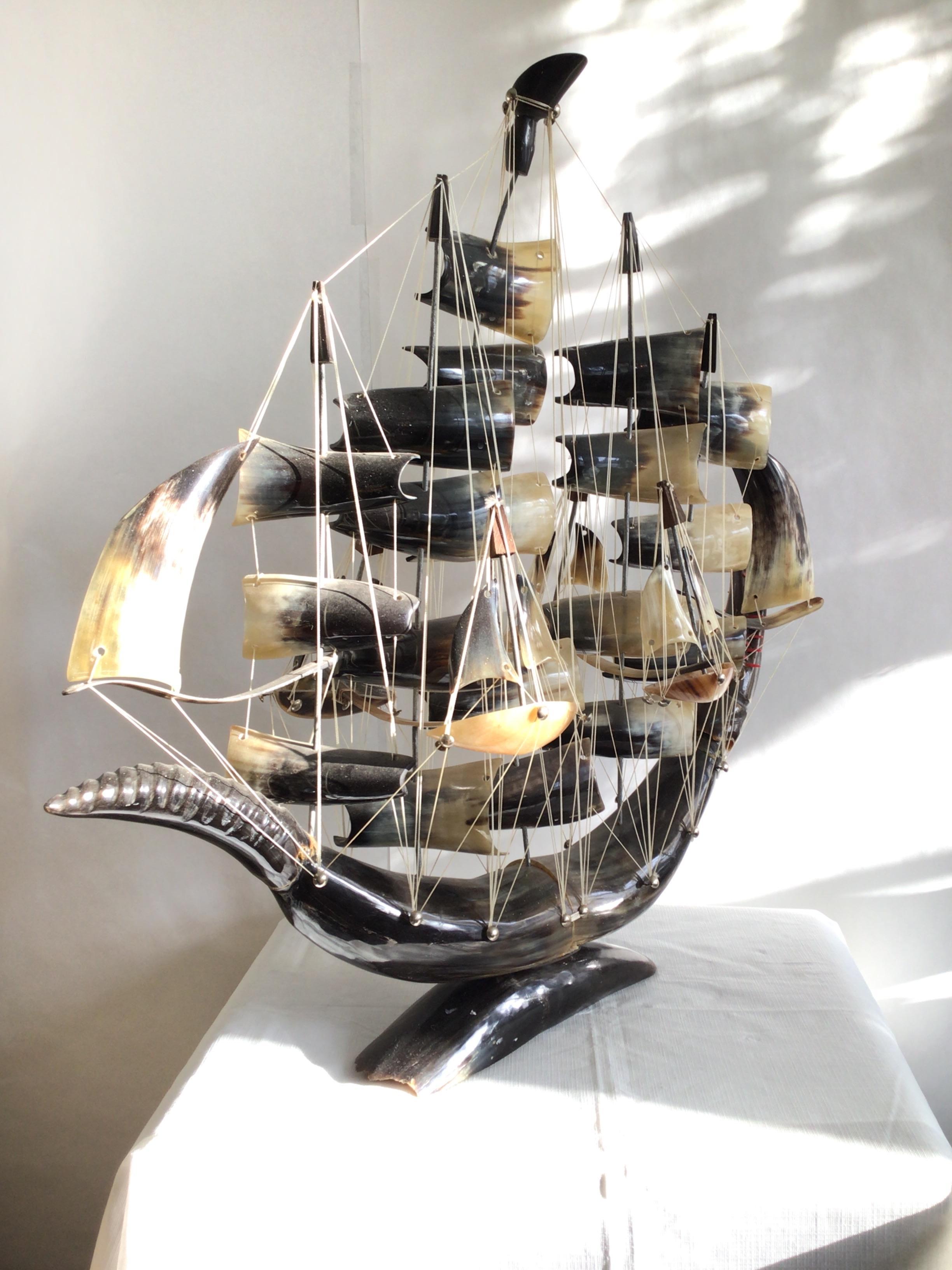 1950s Hand Carved Horn Ship on Horn Base - connected with string
Over 40 pieces of Horn in an impressive Size
Colors: Brown, White, Cream
Sailing ship
Nautical 
Handmade with real Horn bone, it has great details of a five-masted galleon, with
