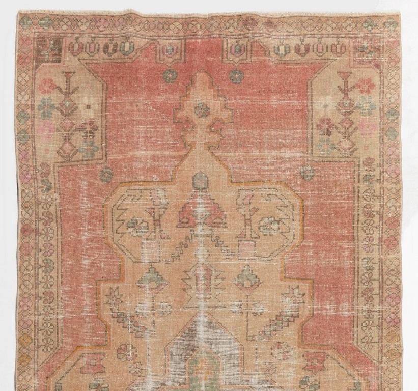 A finely hand-knotted vintage Turkish carpet from 1950s featuring a geometric medallion design. The rug is made of medium wool pile on wool foundation. It is heavy and lays flat on the floor, in very good condition with no issues. It has been washed