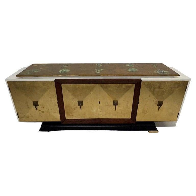 Sensational custom Mexican Modernism
1950s Gold Leaf Credenza Cabinet Mahogany Wood and Brass Mexico
95 w x 36.5 tall x 22 d Drawer 20 x 13 d x 3 tall
Storage right and left 18 x 12 at bottom and 8.5 top 26 wide Middle storage 41.5 w x 17.5 top,
