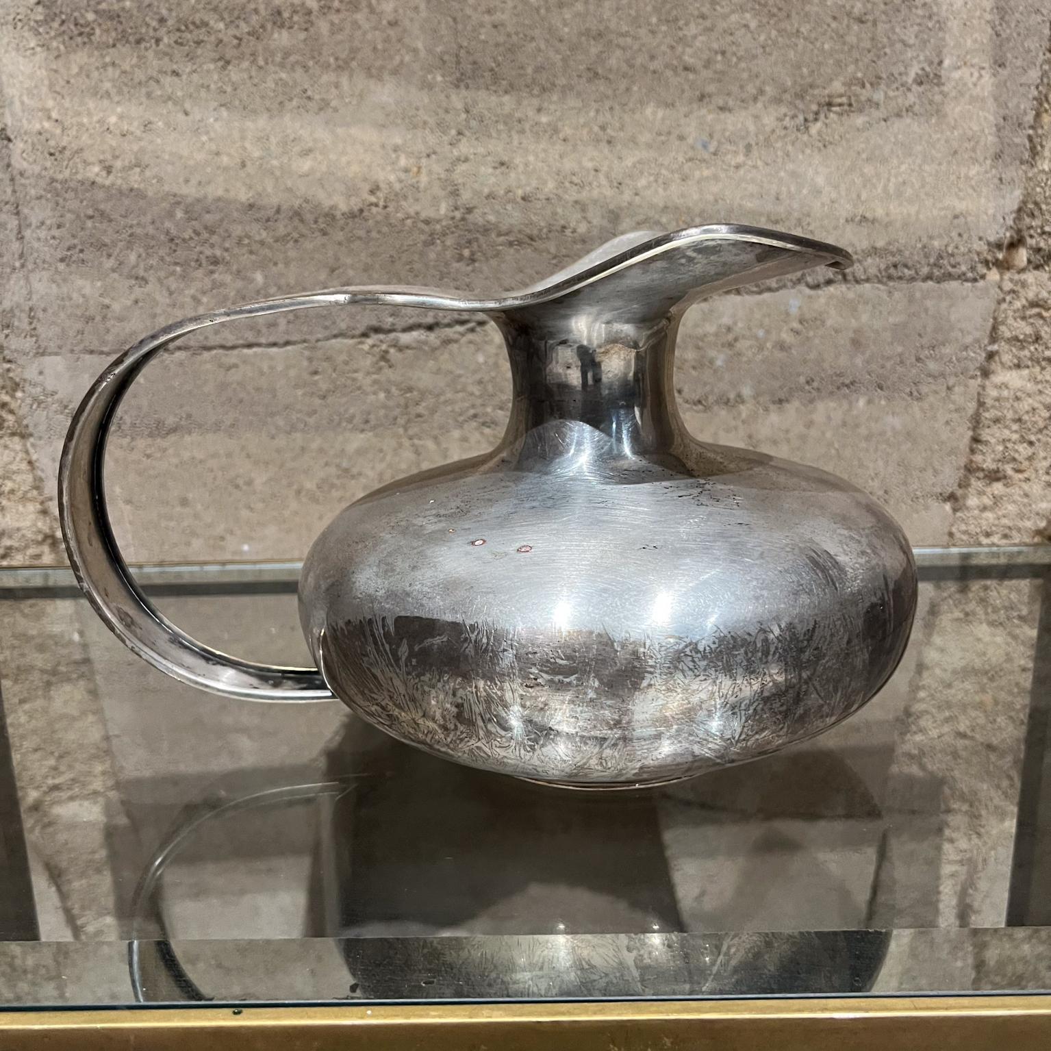 1950s Rubens International Pitcher handcrafted from Mexico 
Silver Plated
maker stamped
7.75 h x 9.5 w x 12.5 d
Original vintage presentation unrestored
Refer to images provided.