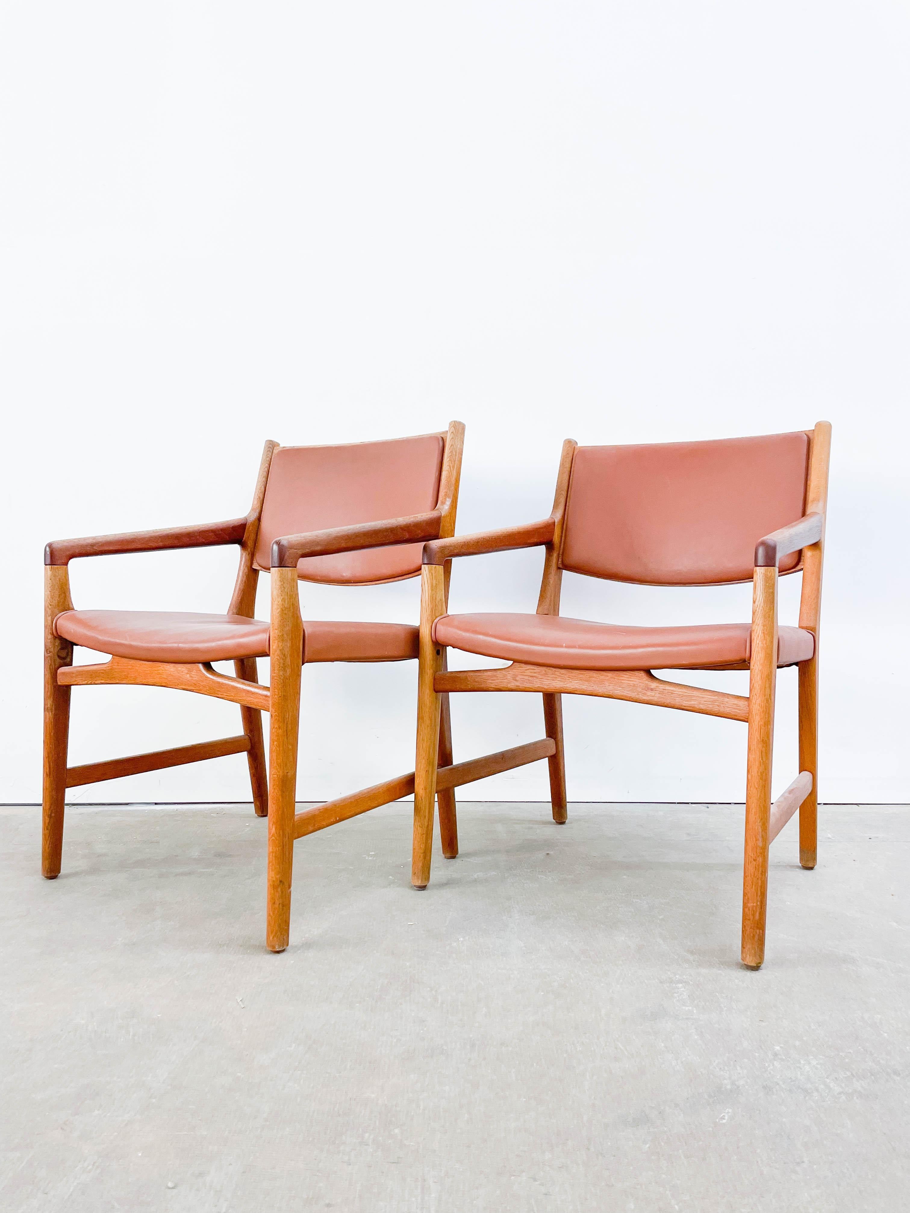 Hans Wegner custom-designed oak and leather chairs for the department store Magasin du Nord. The design was developed specifically for trying on shoes as the angled arms allow for greater arm movement when bending from the waist. Originally in