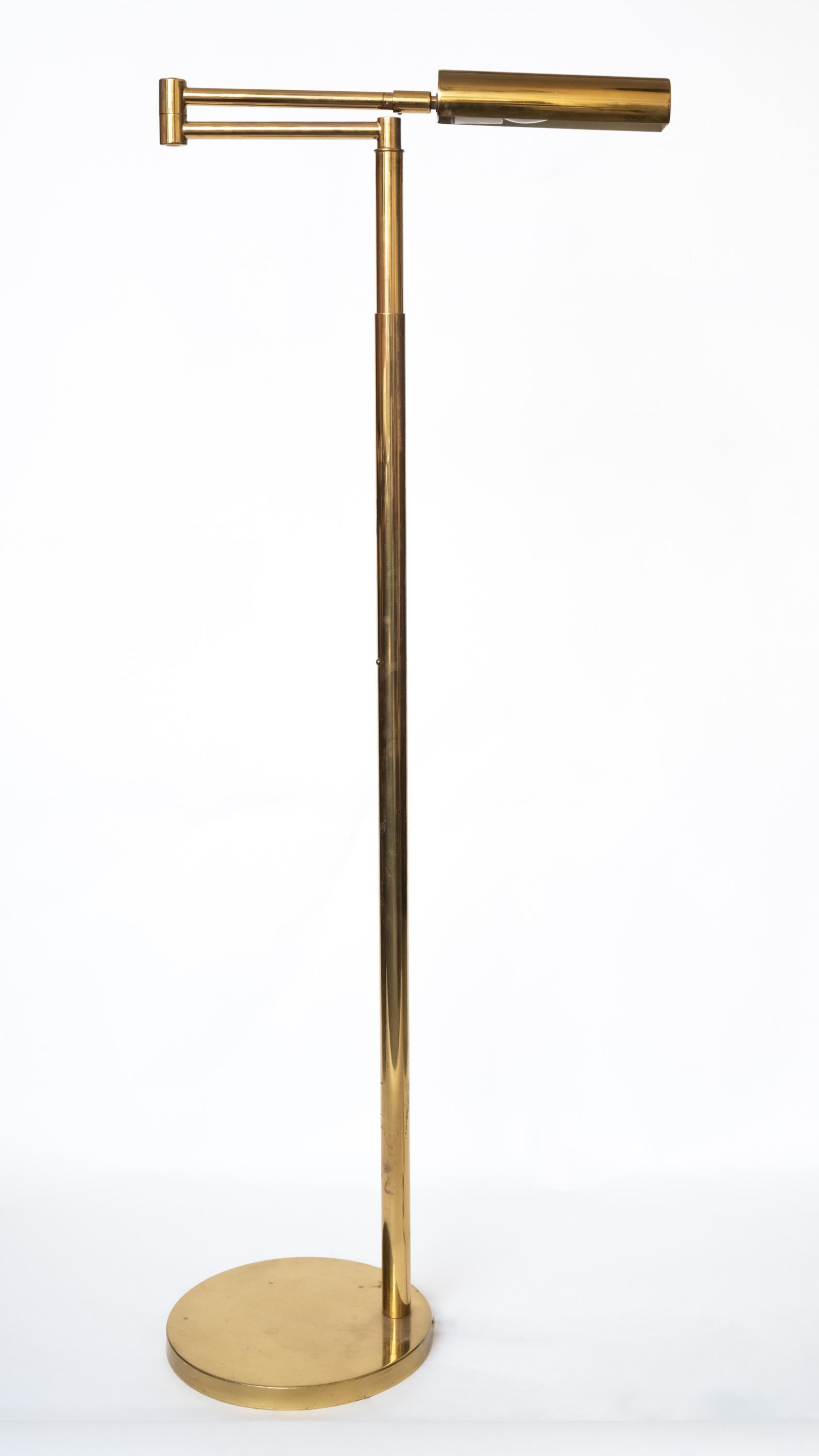 A Mid-Century Modern Brass Floor Lamp having an adjustable and extending arm. The stem sits asymmetrical on the circular base. Some marks and discoloration from age. Circa 1950s 

Longest Arm Length: 24