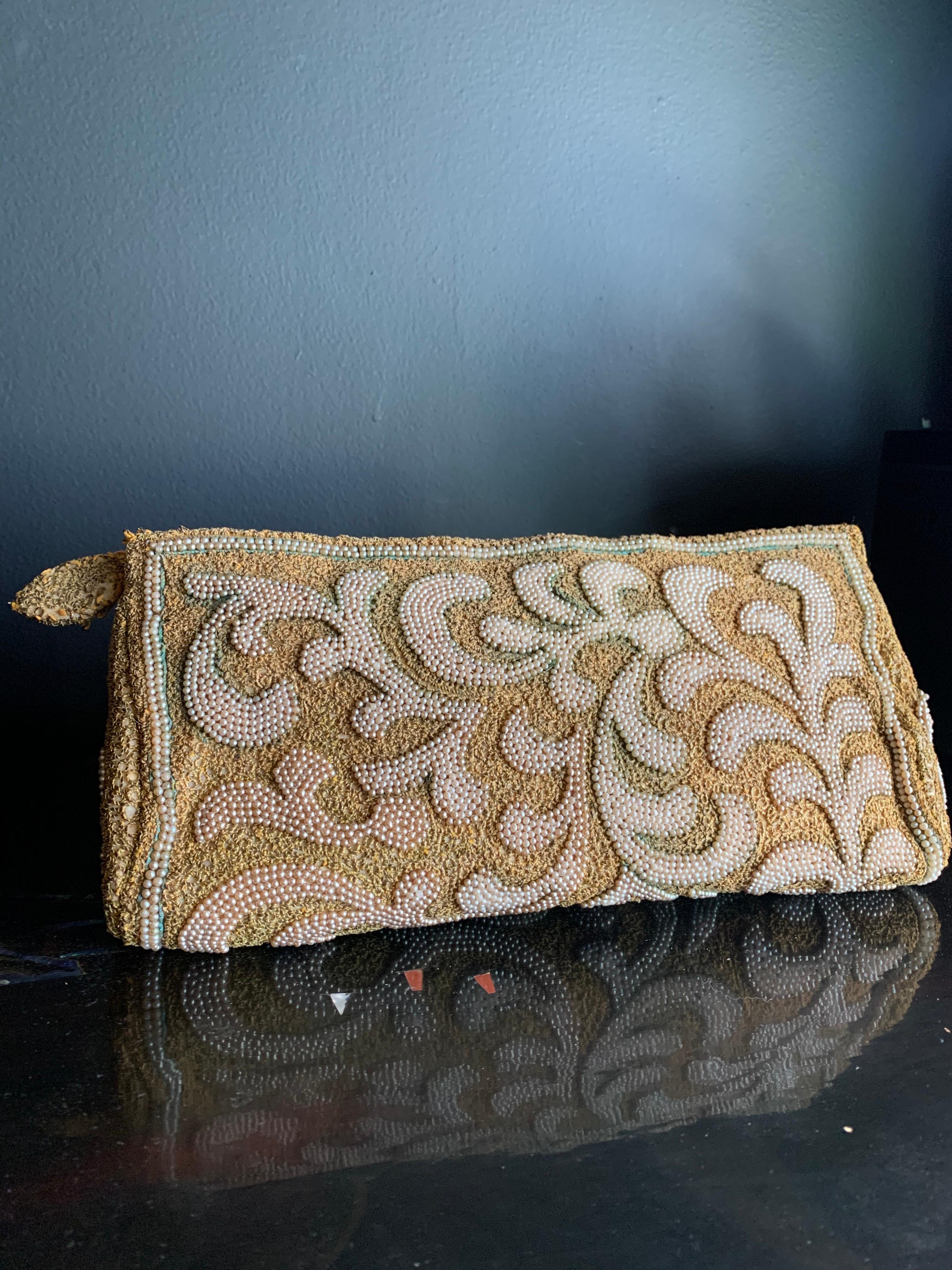 A stunning 1950s Harry Rosenfeld gold filigree lace and faux pearl embroidered evening clutch with embroidered zipper pull. Excellent, clean ivory satin lining with original, chain-tethered coin purse. Some small areas of verdigris on exterior add
