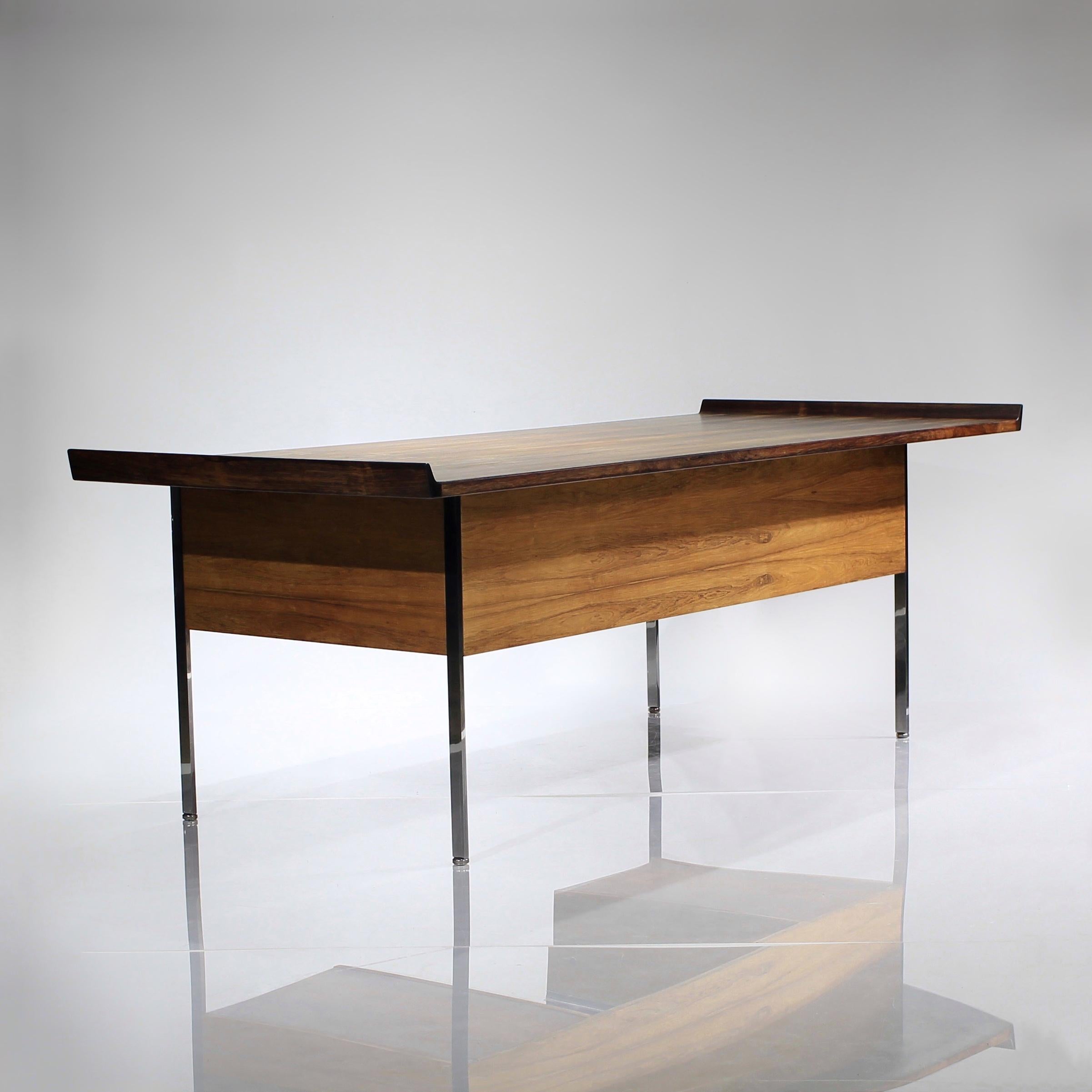 Presenting this extremely rare bleached rosewood executive desk by Harvey Probber. There’s so much to love about this work of art. 

From the mastery of the solid chromed legs, so thoughtfully designed to recess into the corners, to the sculpted