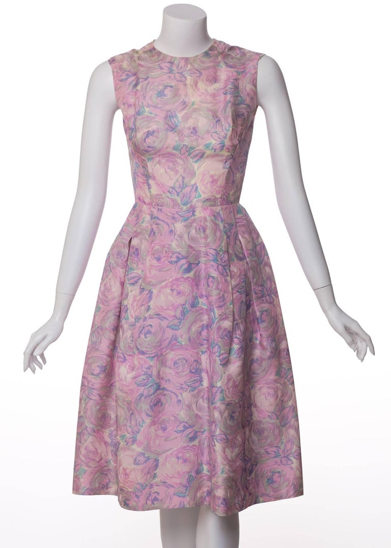 From the early 1950s comes this heavenly silk dress by Hattie Carnegie. Its nipped-waist silhouette is the perfect canvas for the gorgeous watercolor print that unfolds upon it: a blanket of pretty peonies in shades of pink, gray, white, lavender