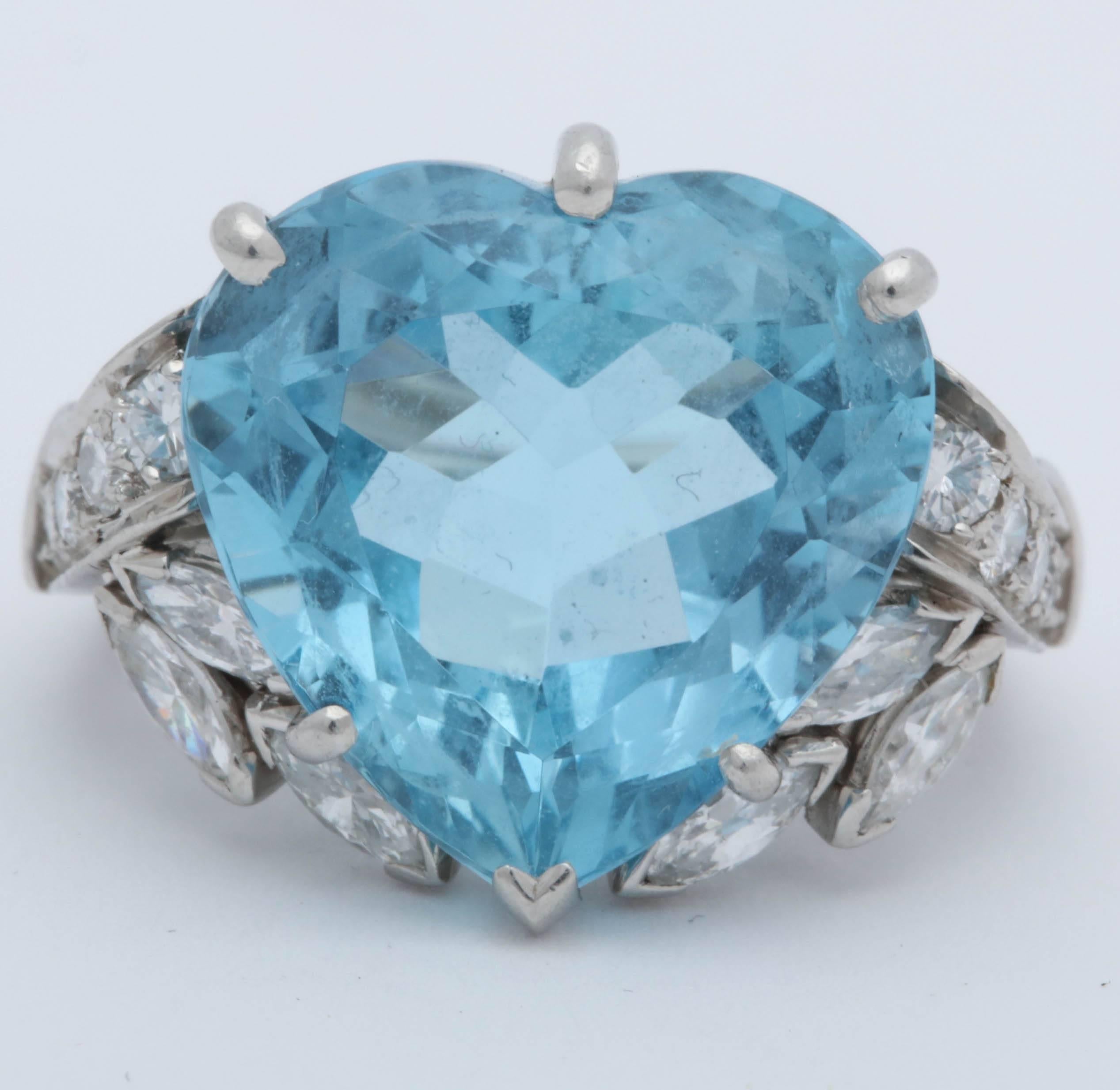 One Ladies Platinum Mounting Ring Designed With One Large Heart Shaped Cut Prong Set Aquamarine Stone Weighing Approximately 20 Carats. Ring Is Flanked by Numerous Round Cut And Marquis Shaped High Quality Diamonds Weighing Approximately 1.50 Cts