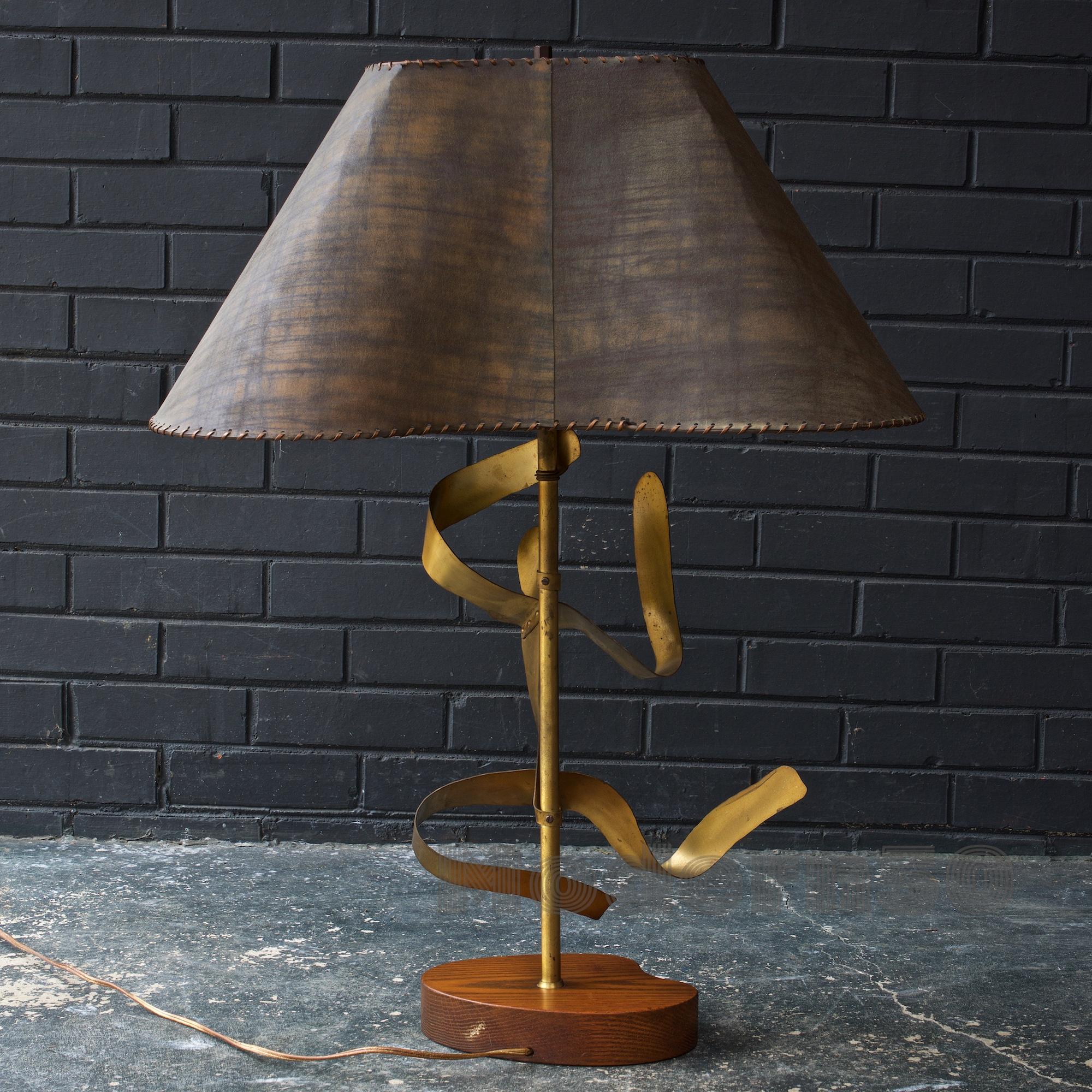 Lamp with the original shade and finial.
Measures: Lampshade is 24 x 15.5 x 11 in.
Lamp body 13 x 7 x 32 in.
