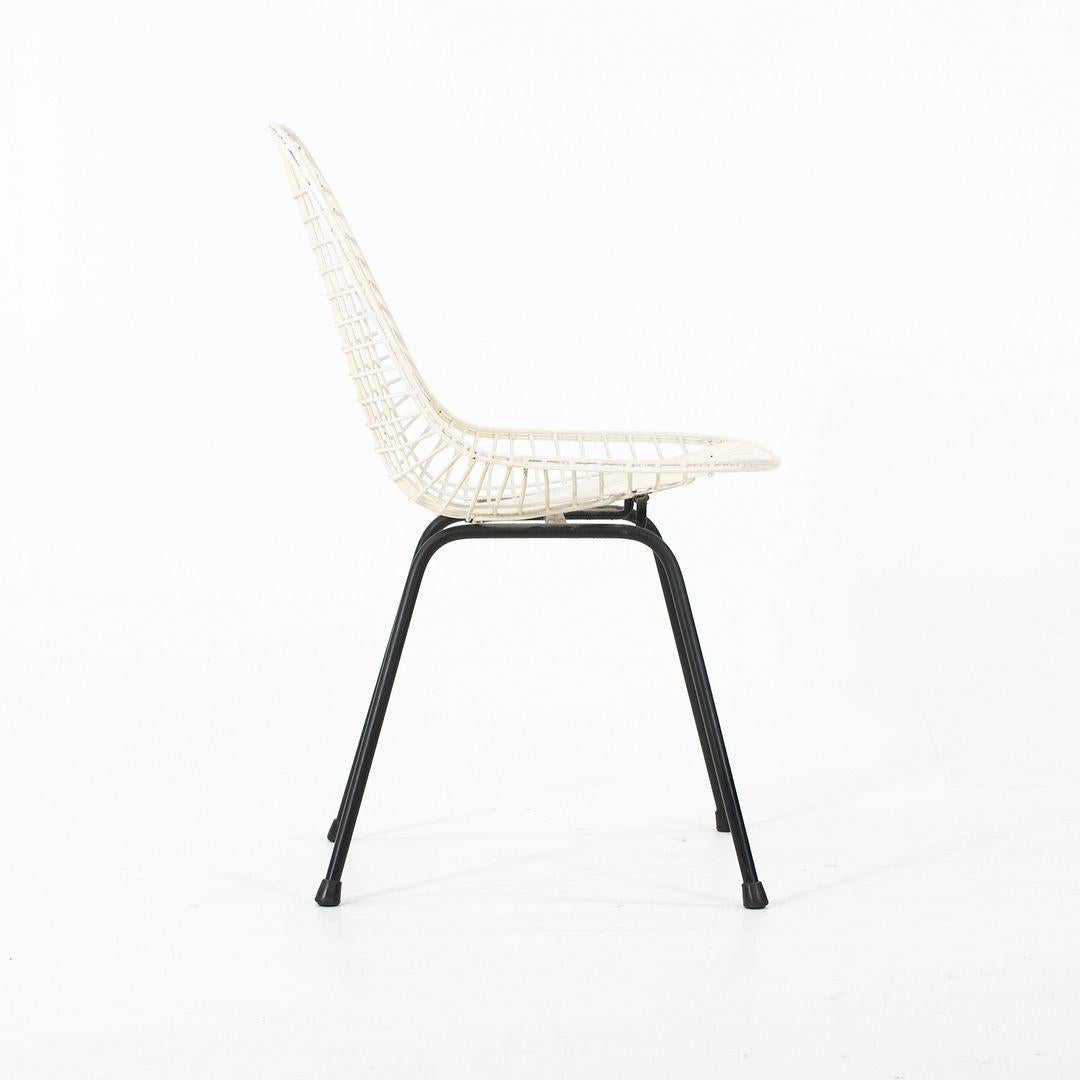 This is a DKX chair, originally designed by Ray and Charles Eames in 1951. This particular example was produced by Herman Miller in the USA in the 1950s. The chair is comprised of a steel wire seat in white atop a black steel X-base. DKX is an