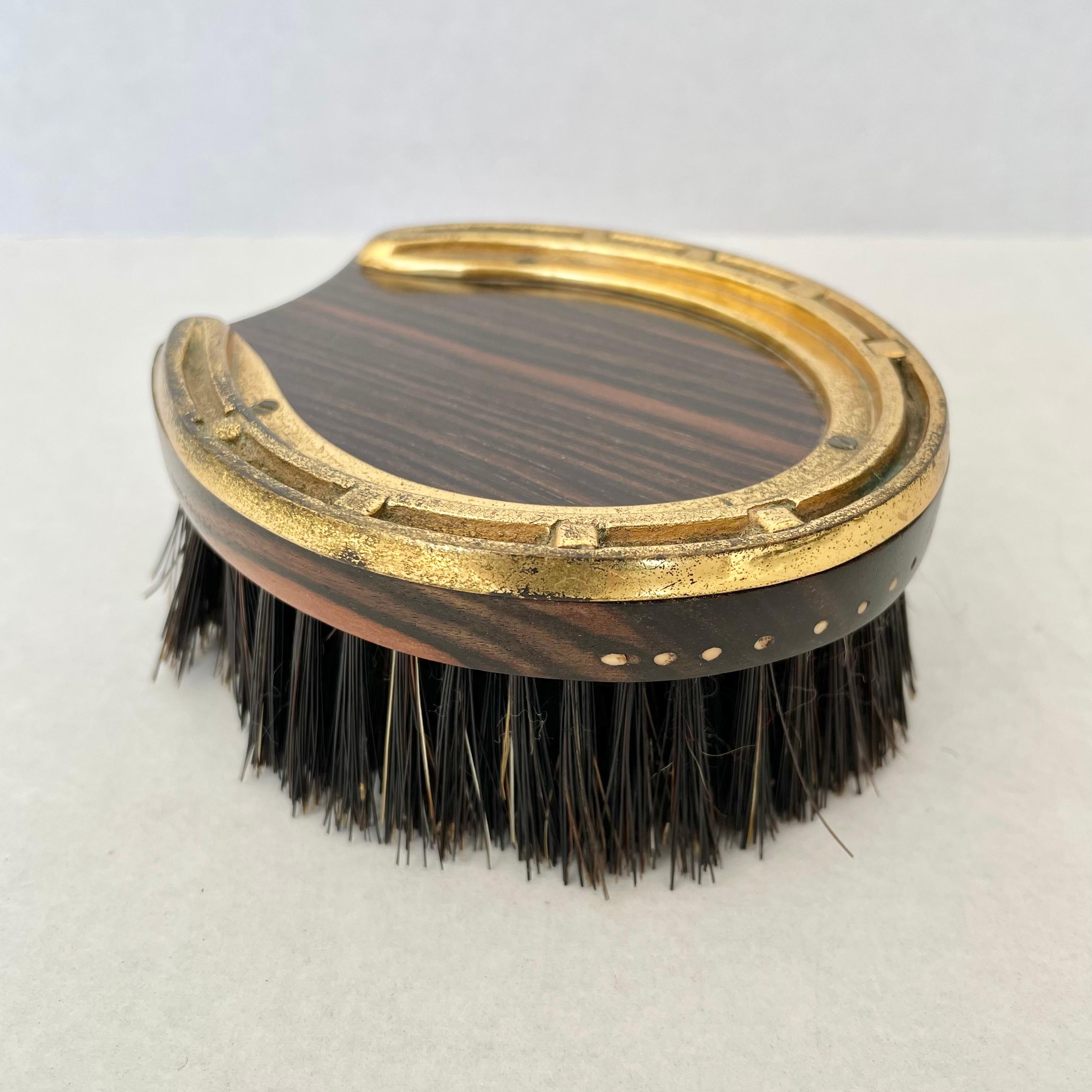 Beautiful Hermès clothing brush. Made from rare Ebony Macassar wood, boar bristles and brass. This brush is meant to preserve the life and appearance of clothing and fabrics by keeping the garment threads from getting matted down or looking worn or