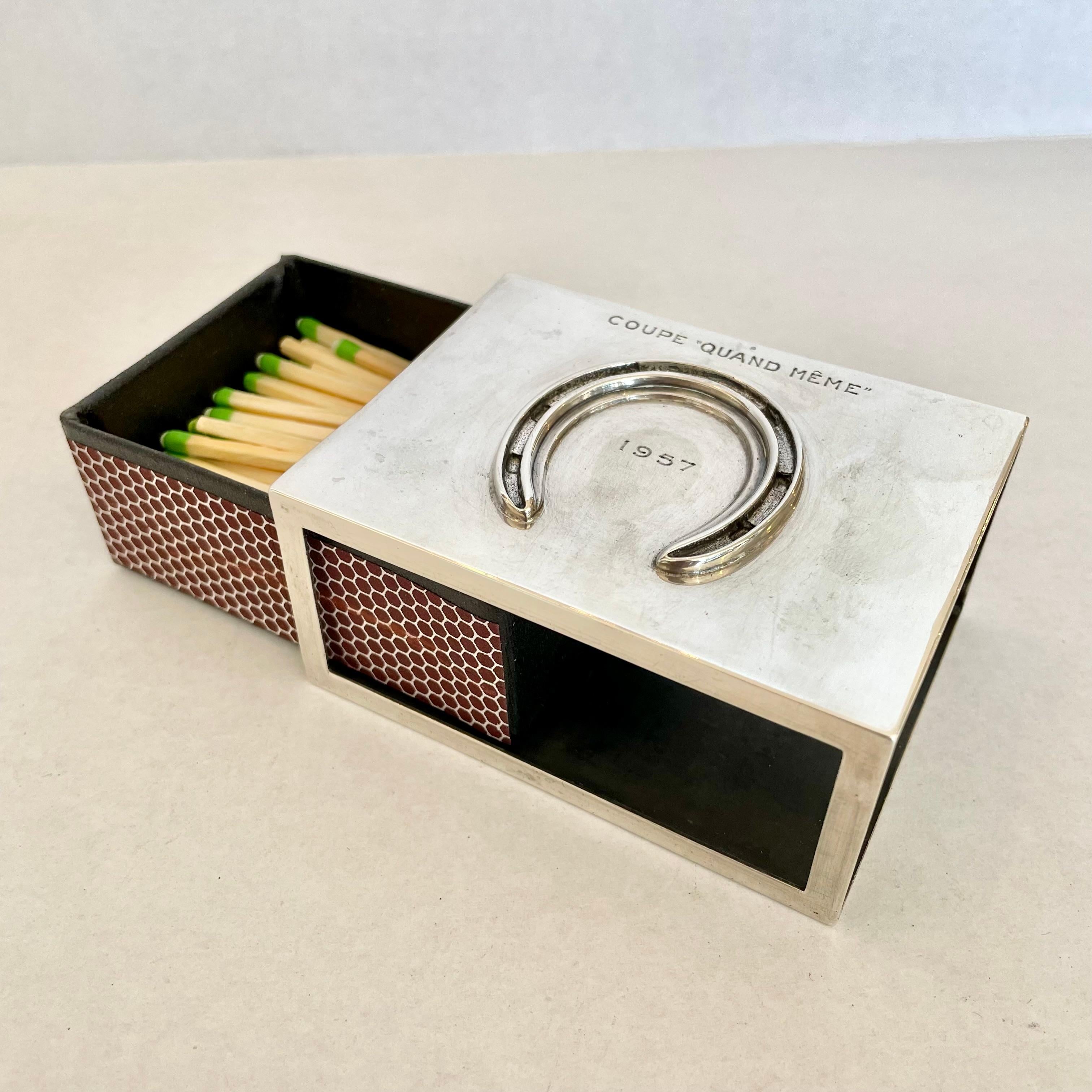 Classic vintage Hermès matchbox. Matchbox has a metal sleeve with a horseshoe insignia. Inset leather box that fits into the metal sleeve. Engraved Hermes Paris on bottom of matchbox. Beautiful accent piece to elevate any nightstand, desk or side
