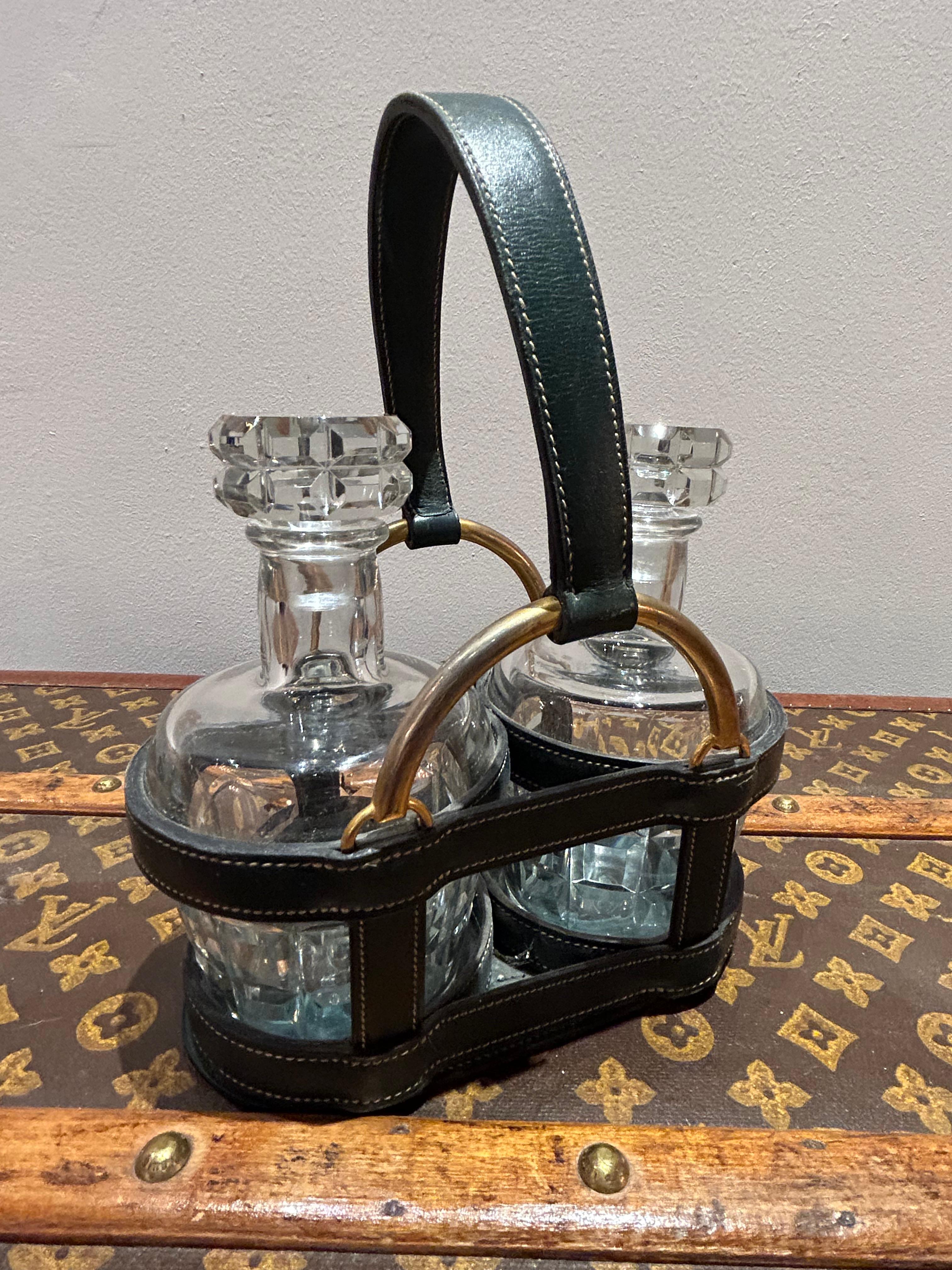 Beautiful 1950's Dual Decanter Hermès Holder, including two crystal decanter together in a green leather stitched Hermes look a like basket.

Dimensions: Height 25cm, width 20cm, depth 11cm 

Condition: Please view the very detailed pictures as they