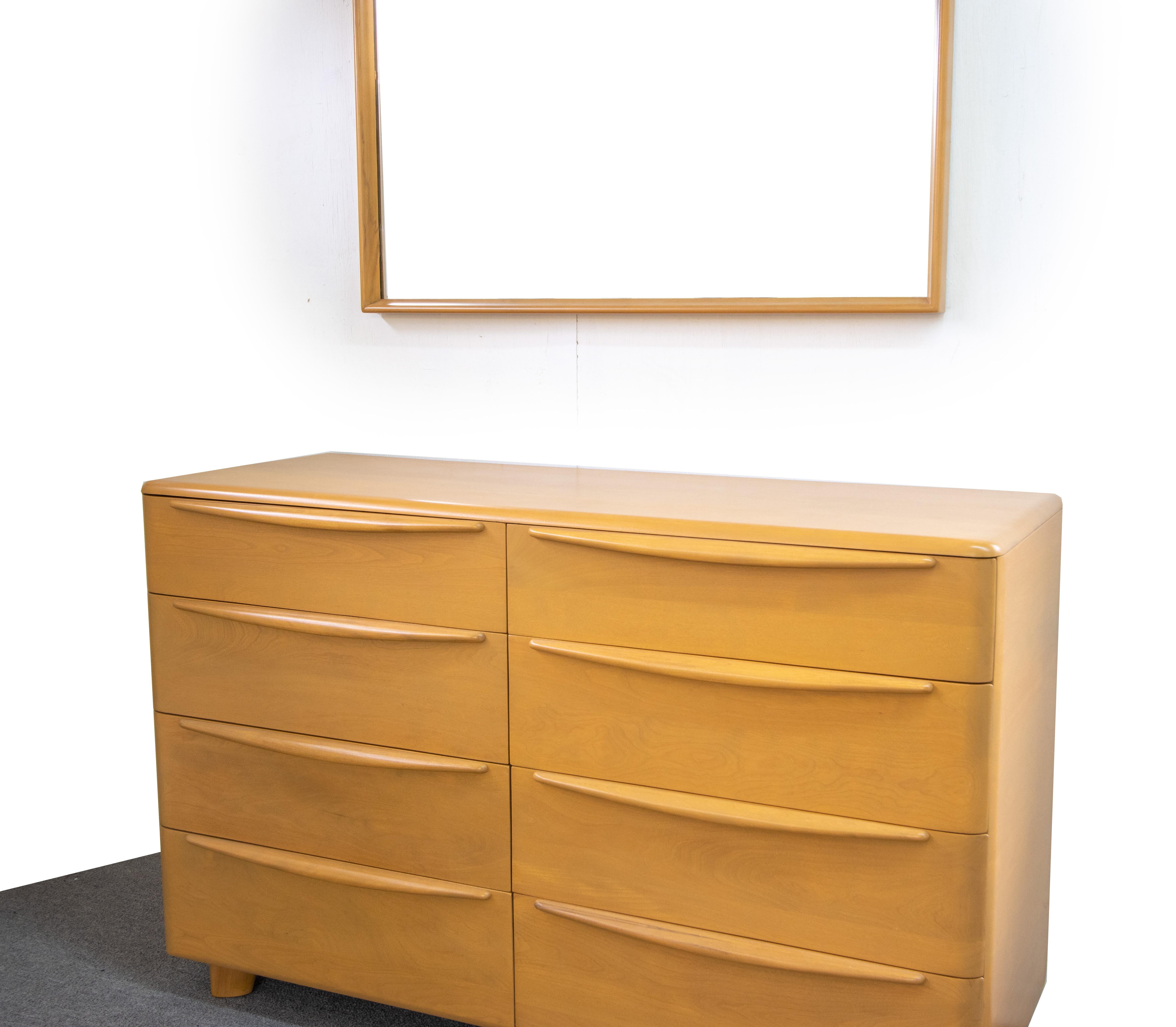 An exceptional 1950s, Heywood Wakefield Encore 8 drawer low dresser in a beautiful wheat color.  Matching mirror included.  Great rounded edges with elongated drawer pulls that span the width of the drawers. This piece was stripped and