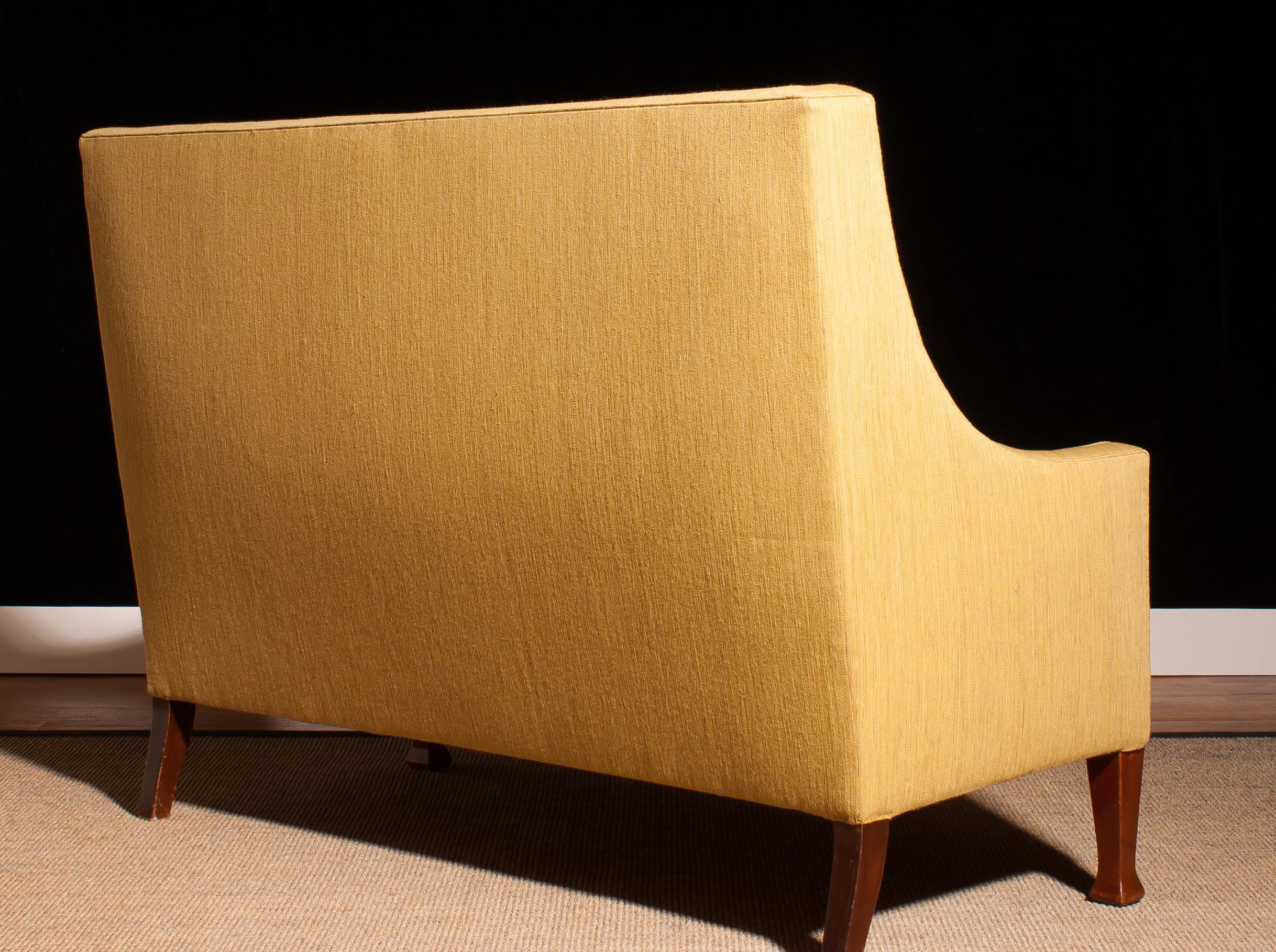 Beautiful high back sofa couch made in Denmark.
The sofa is made of a light yellow fabric on a wooden frame.
It is in a wonderful original condition,
period 1950s.
Dimensions: H 108 cm, W 148 cm, D 75 cm, SH 46 cm.