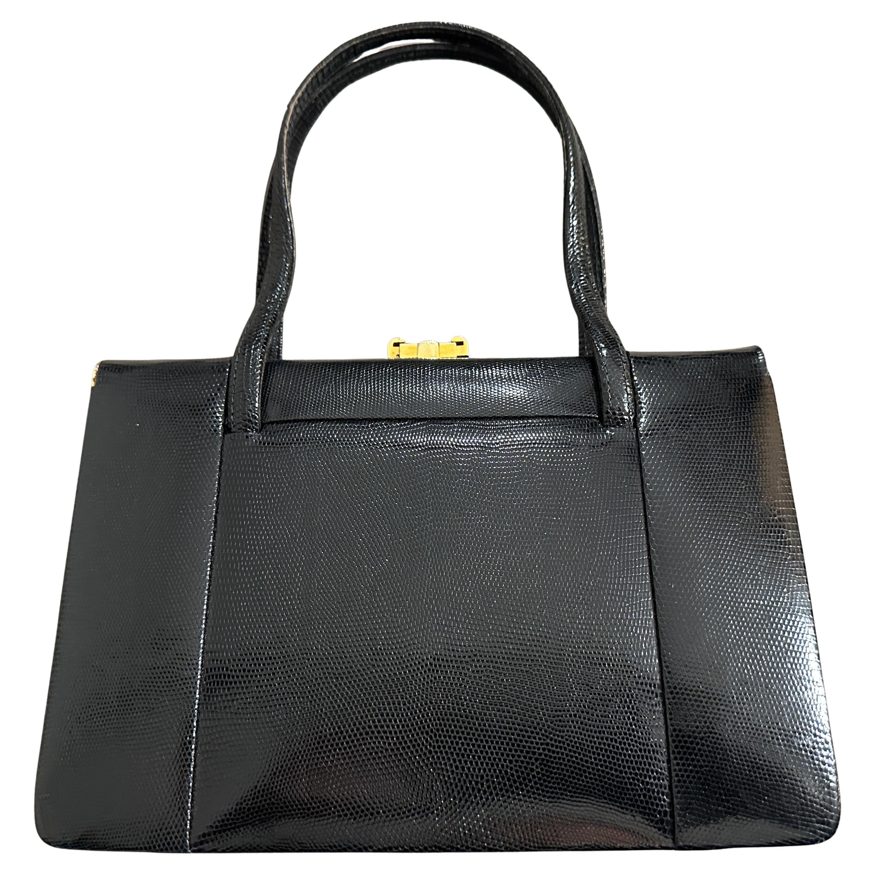 Exquisite Vintage 1950s Italian Black Leather Evening Bag
Embody classic 1950s elegance with this stunning black leather evening bag, a testament to high-quality Italian craftsmanship. This sophisticated accessory is a timeless piece that will