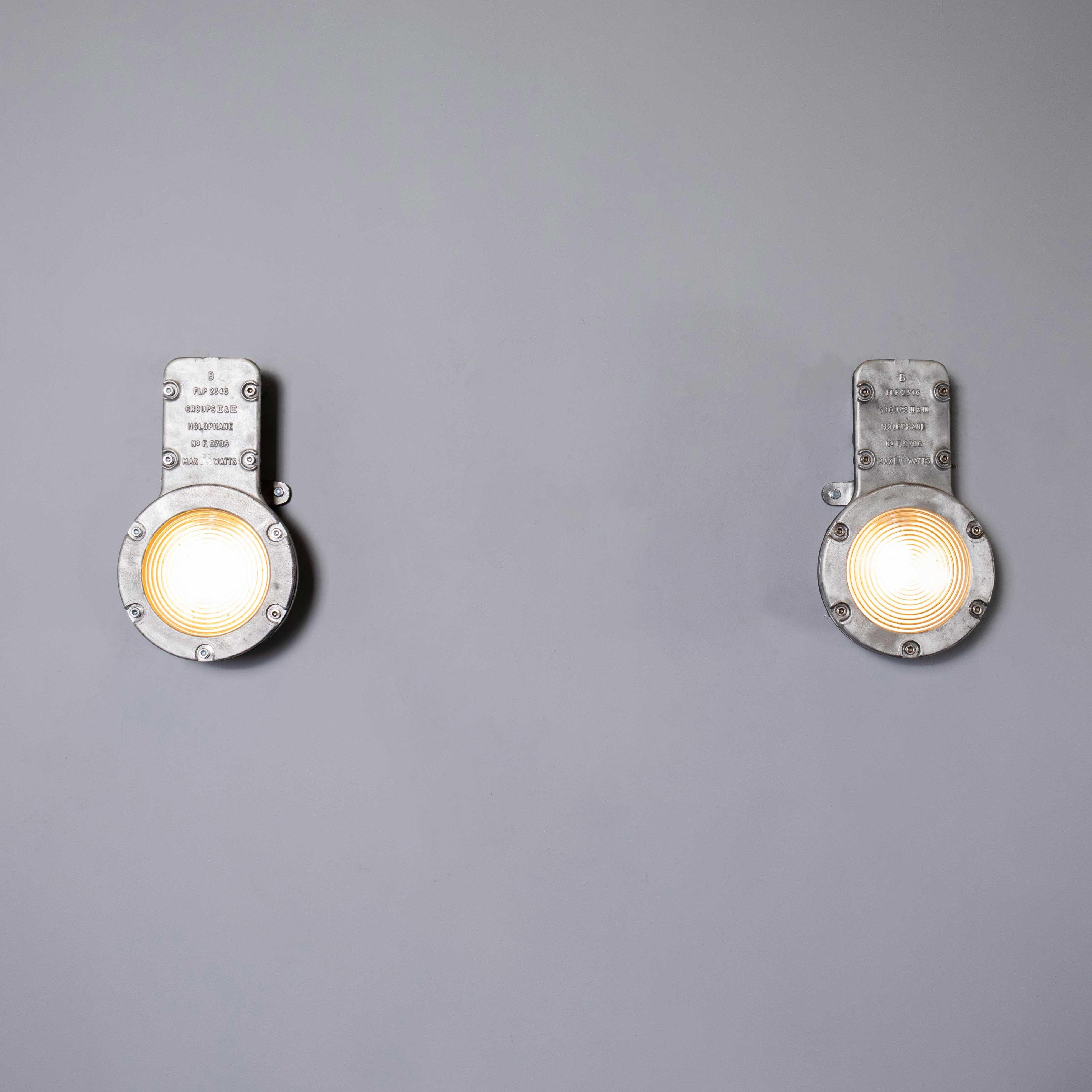 1950’s Holophane Large Cast Bulkhead Lamp – Pair. Holophane was founded in England in the late 19th Century and they are famous for their inventing and perfecting borosilicate glass reflectors often with intricate cast glass patterns which give a