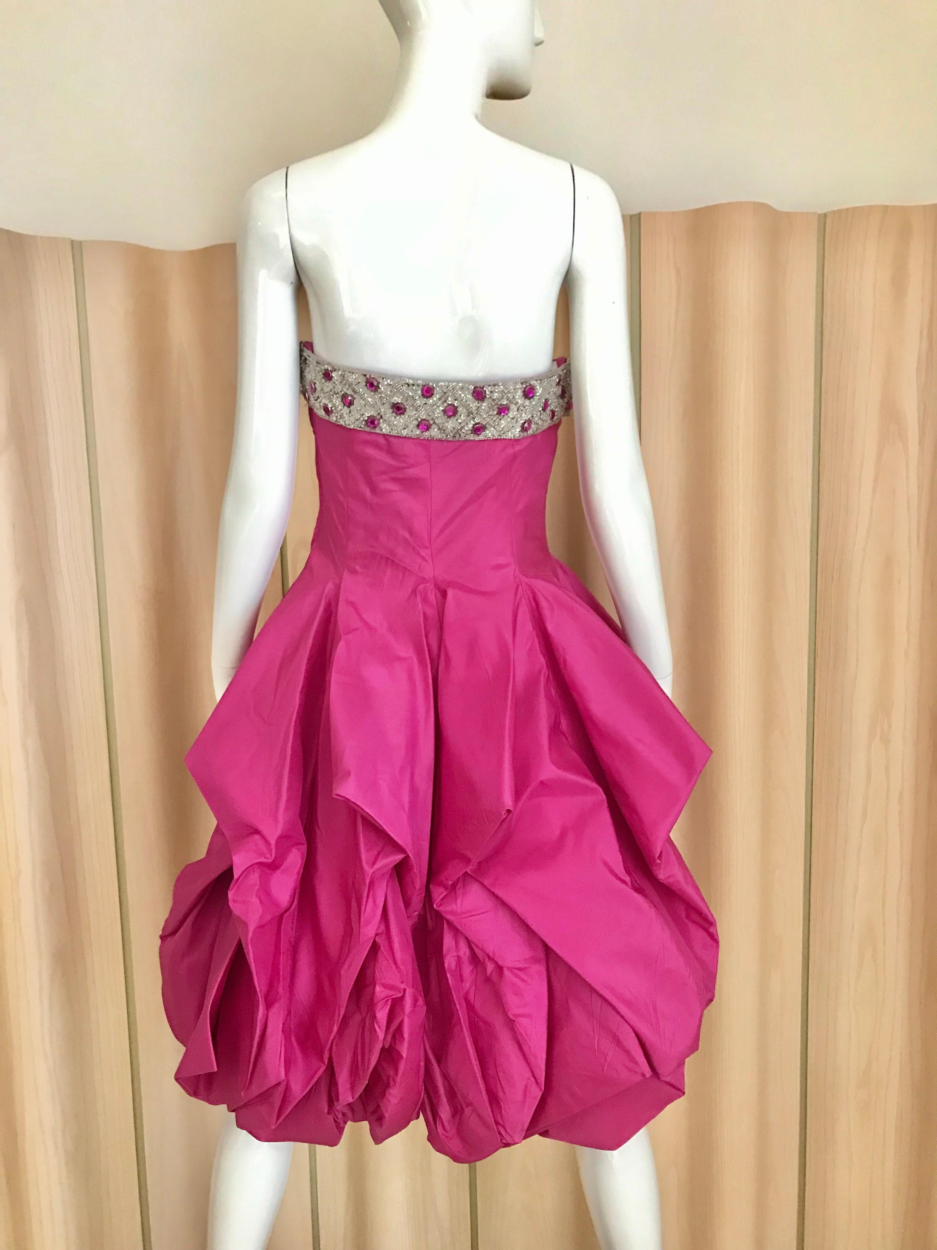 Vintage 1950s Hot pink silk strapless cocktail dress with beaded bust and peplum hem.
Bust: 34 inches / Waist: 29” / dress length ; 33