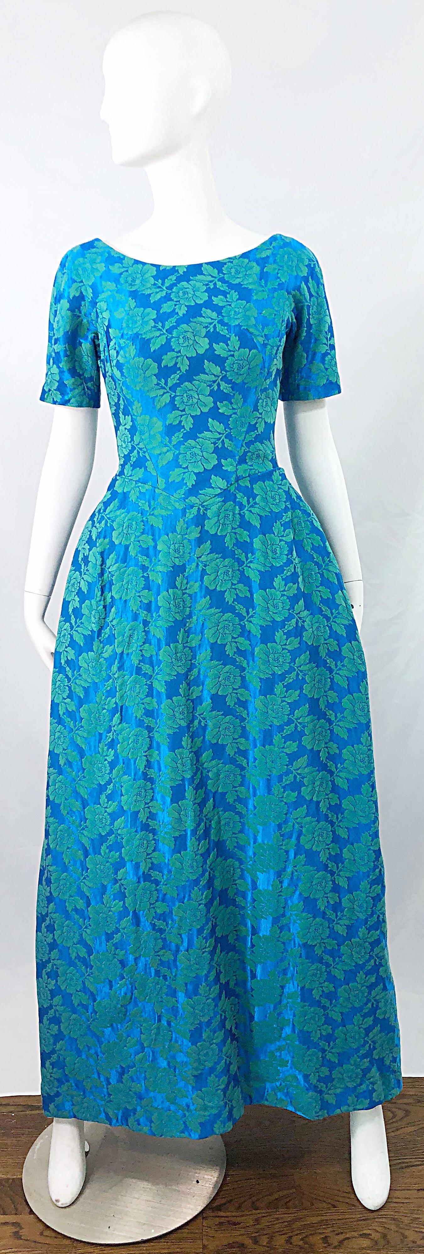 Gorgeous early 60s HOUSE OF BIANCHI turquoise blue silk brocade short sleeve gown / dress ! Features a vibrant turquoise blue silk with lighter green / blue flower brocade throughout. Tailored bodice with a full forgiving skirt. Full metal zipper up