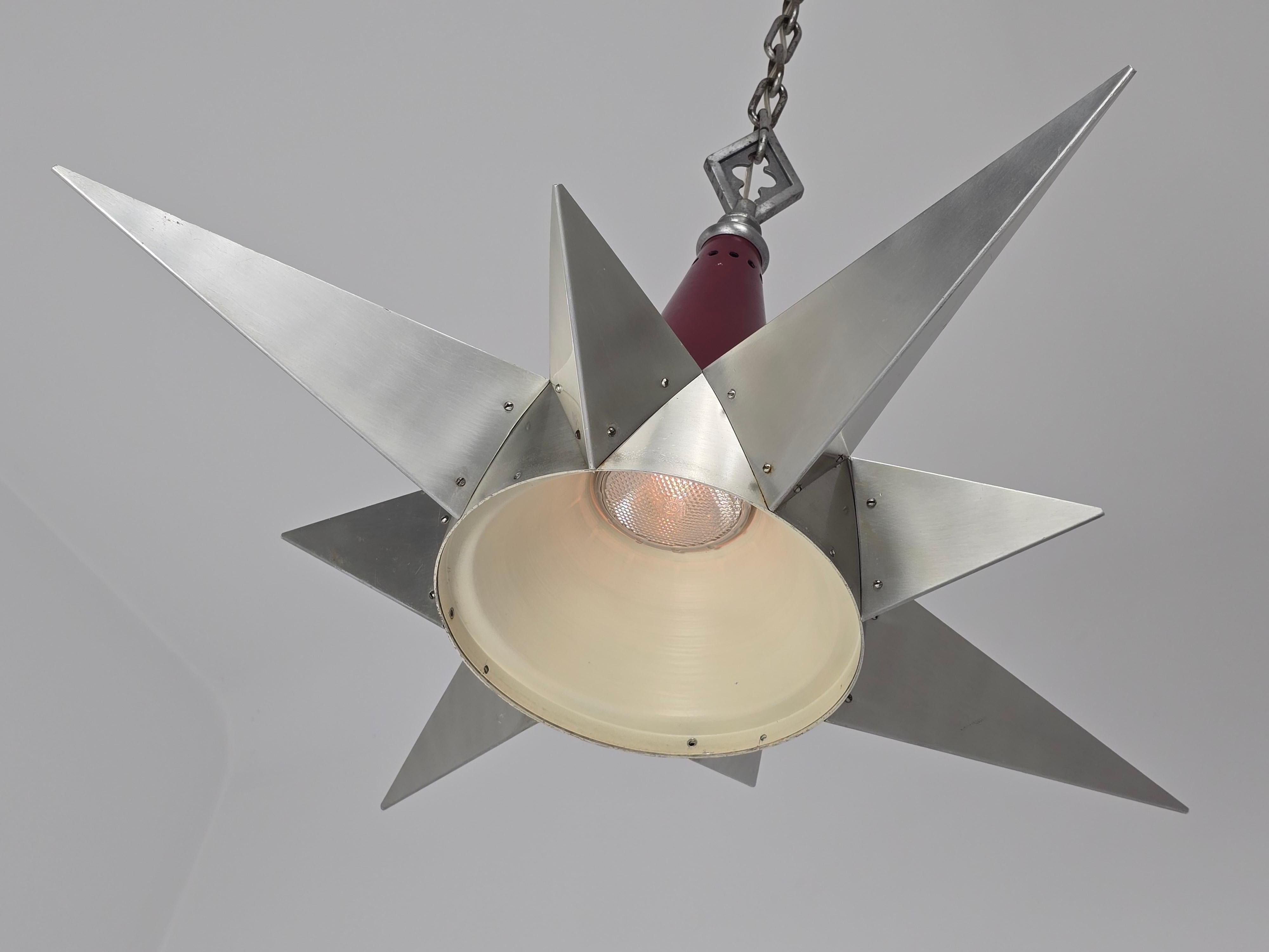 A unique 1950s  star shaped  church pendant made of aluminium with 4 lights shooting upward and one spotlight firing downward . 

Well made structure and hardware with nice detail . 

Solid sturdy construction . 

Contain 4 E26 / E27  ceramic