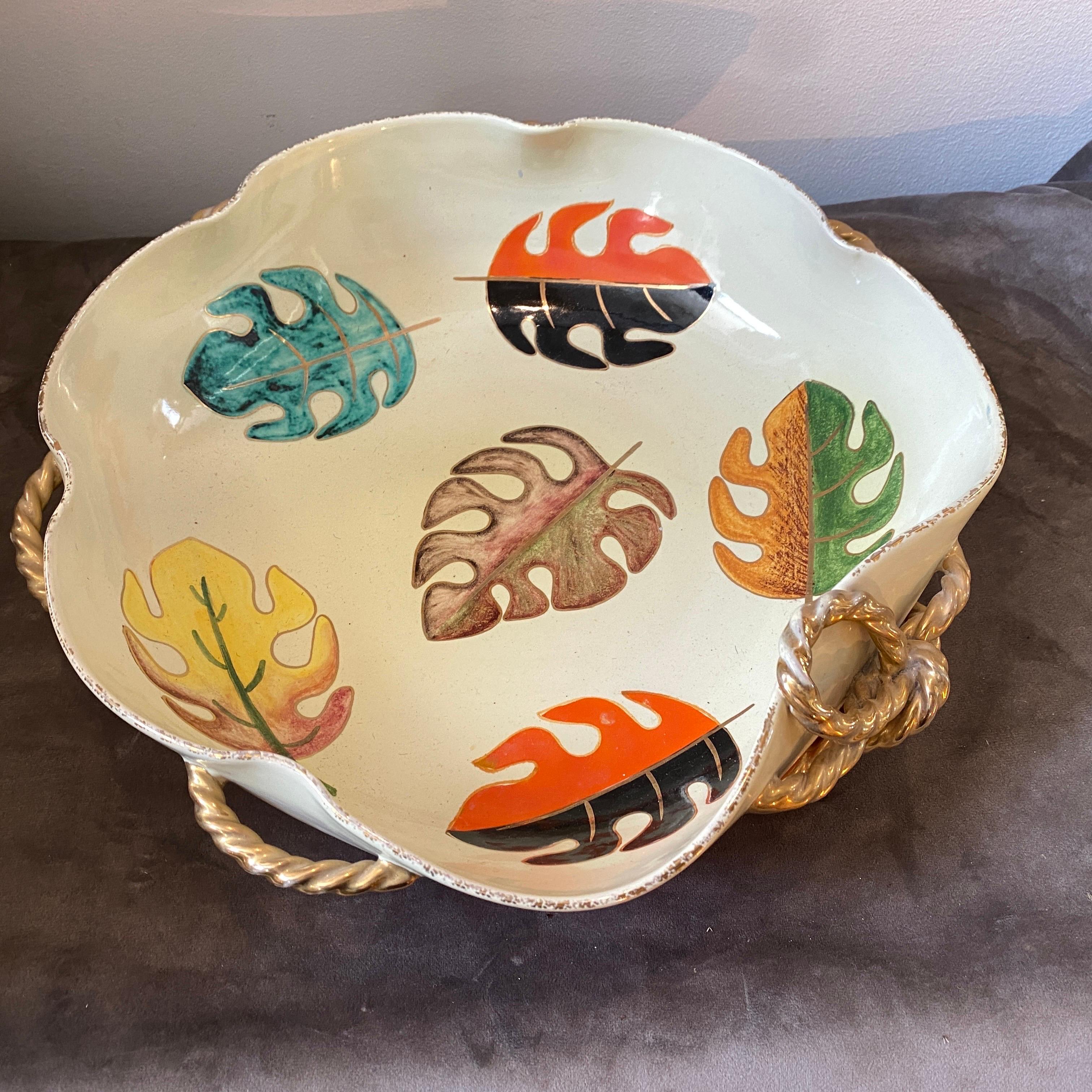 A stylish ceramic centerpiece designed and hand-crafted in Italy by world famous italian manufacturer Pucci, the colors and the shape are iconic of the producer. It's signed on the bottom. The bowl has normal signs of use and age.
