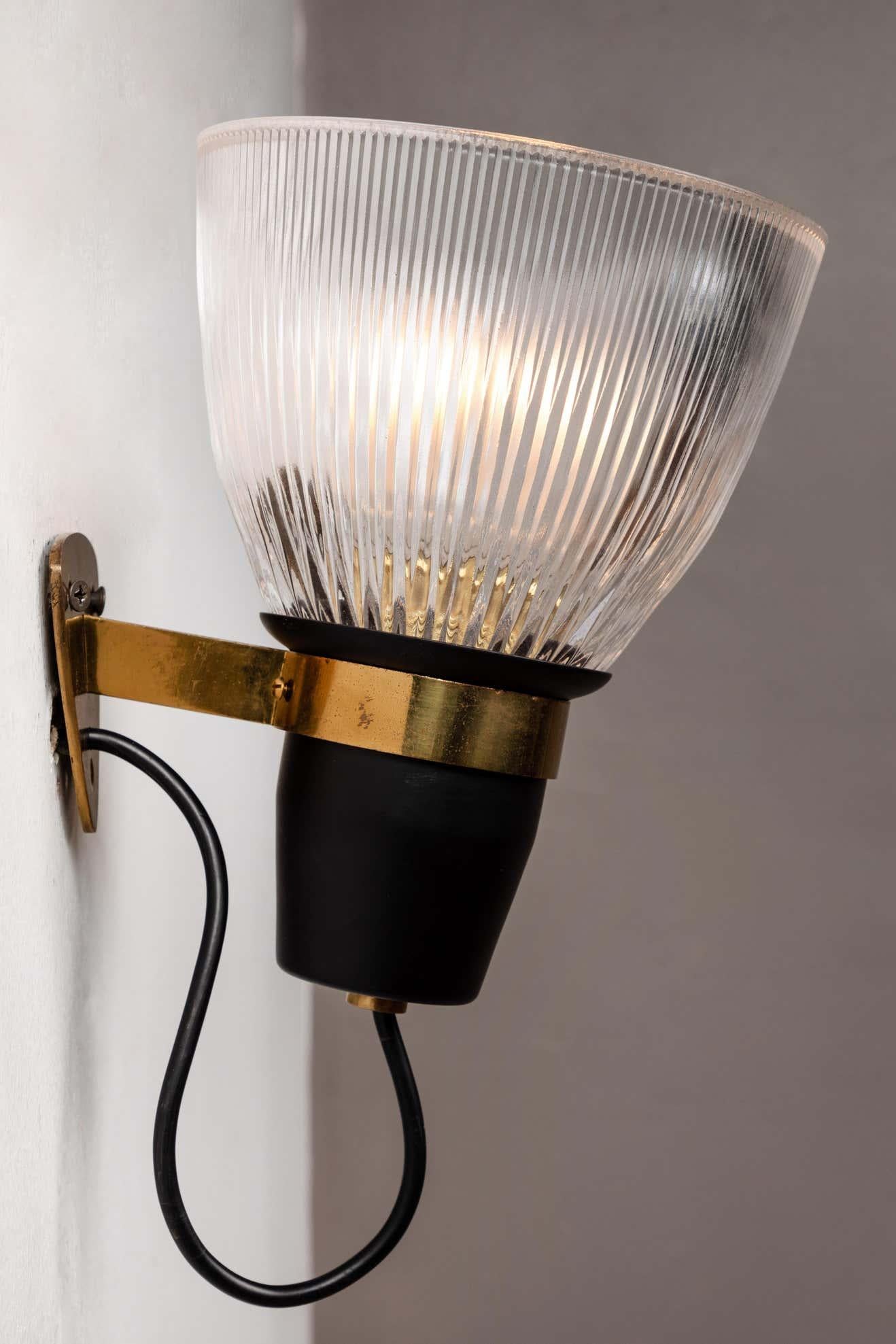 1950s Ignazio Gardella LP5 Sconces for Azucena. These iconic sconces are executed in opaline pressed glass, black painted metal and brass. Several of the lamps feature the 