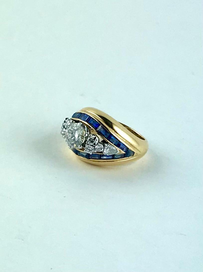 Extremely elegant Illario geometric Ring finely crafted in Italy in 1956 in rich 18 karat polished Yellow Gold and  brilliant cut Diamonds set in Platinum and baguette cut Sapphires.
The central Diamond weighing approximately 0.99 carats and the