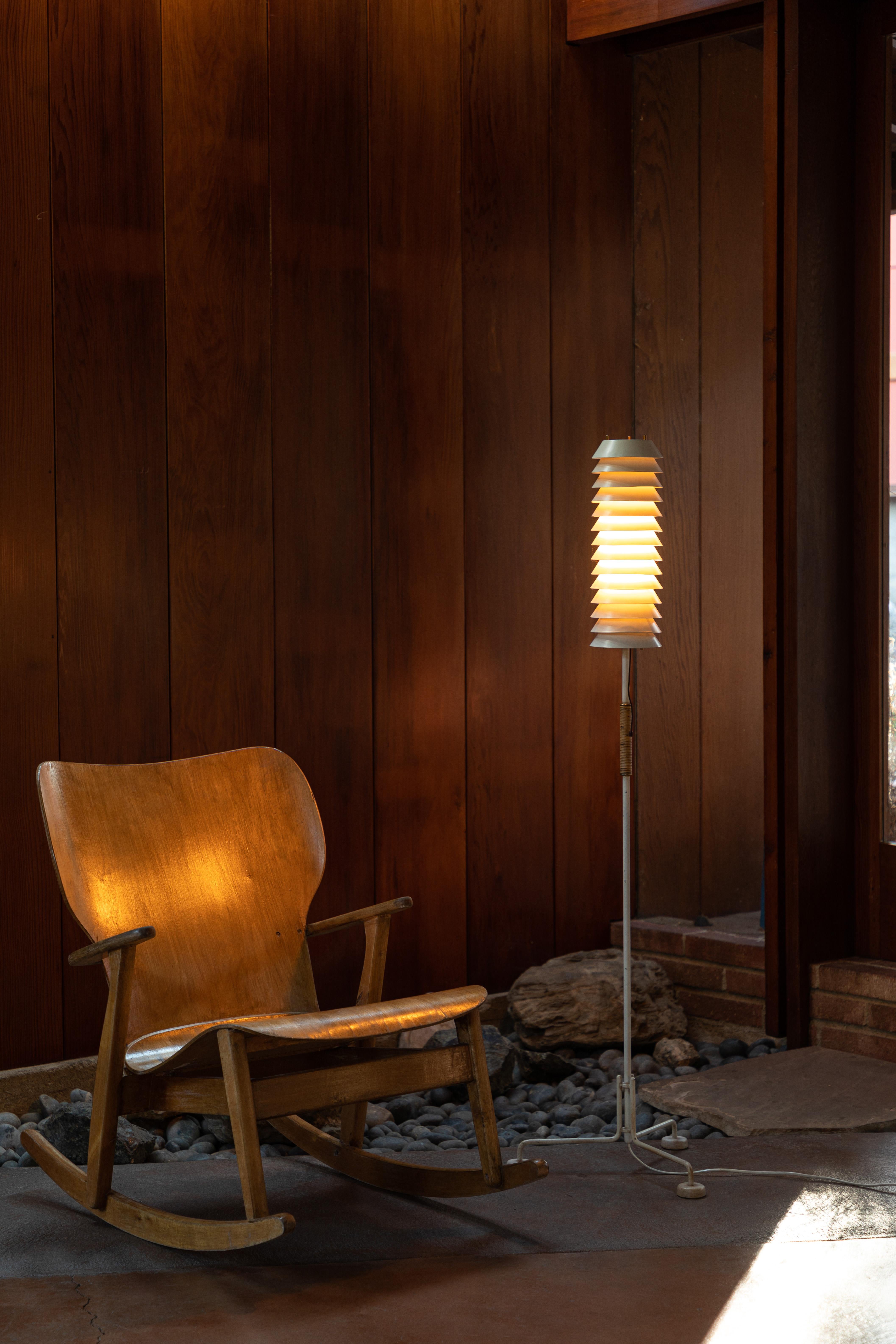 1955, Ilmari Tapiovaara 'Maija' floor lamp for Asko/Hienoterä. A rare original vintage edition made in Finland and executed in painted metal with brass hardware and rattan. This highly refined and sculptural lamp casts beautifully diffused slices of