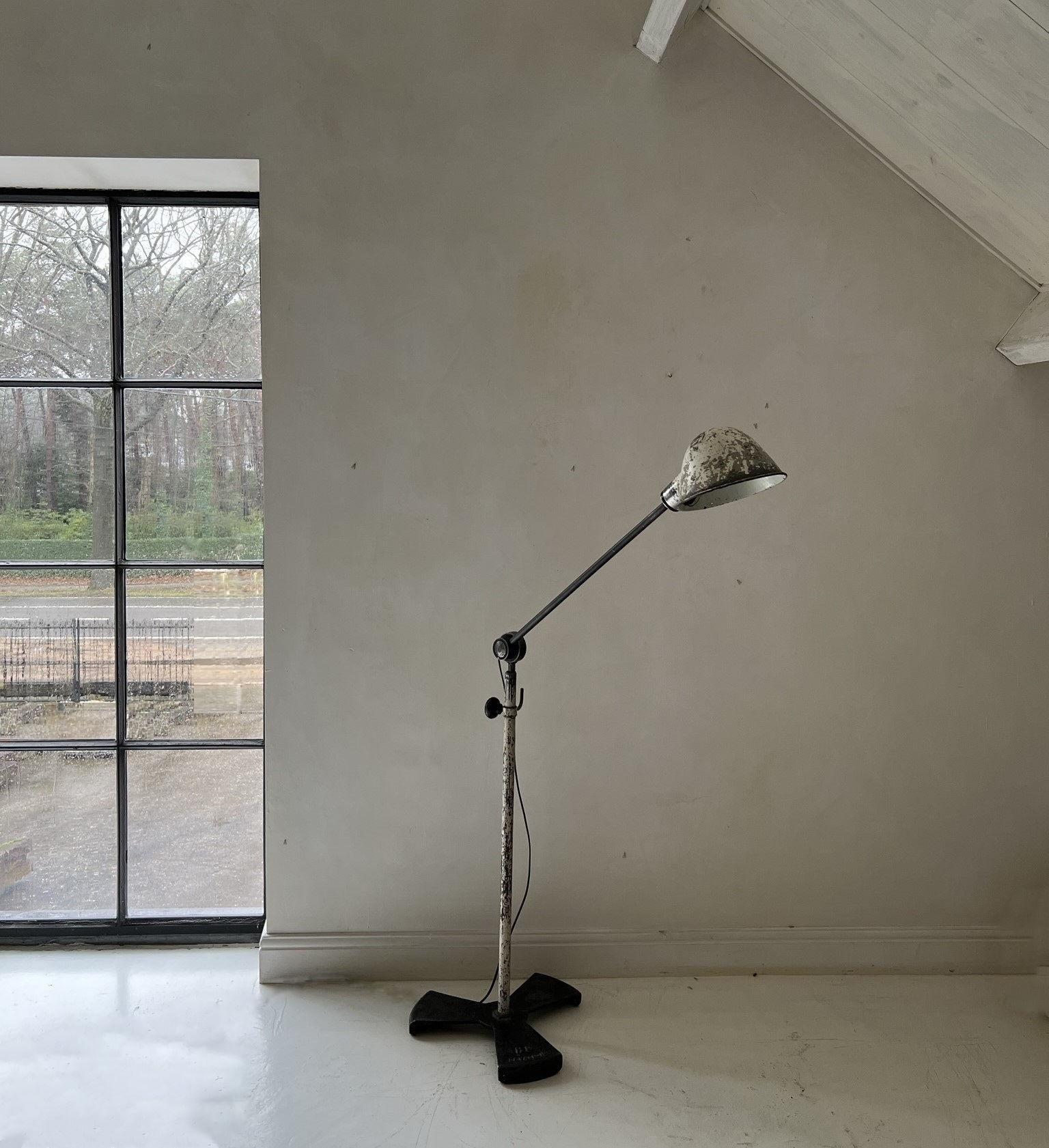 Beautiful example of a midcentury Industrial style floorlamp by the French company Levallois. Unique feature is the original faded paint with great patina. The lamp is working perfect aswell as the tilting mechanisme which goes from vertical to